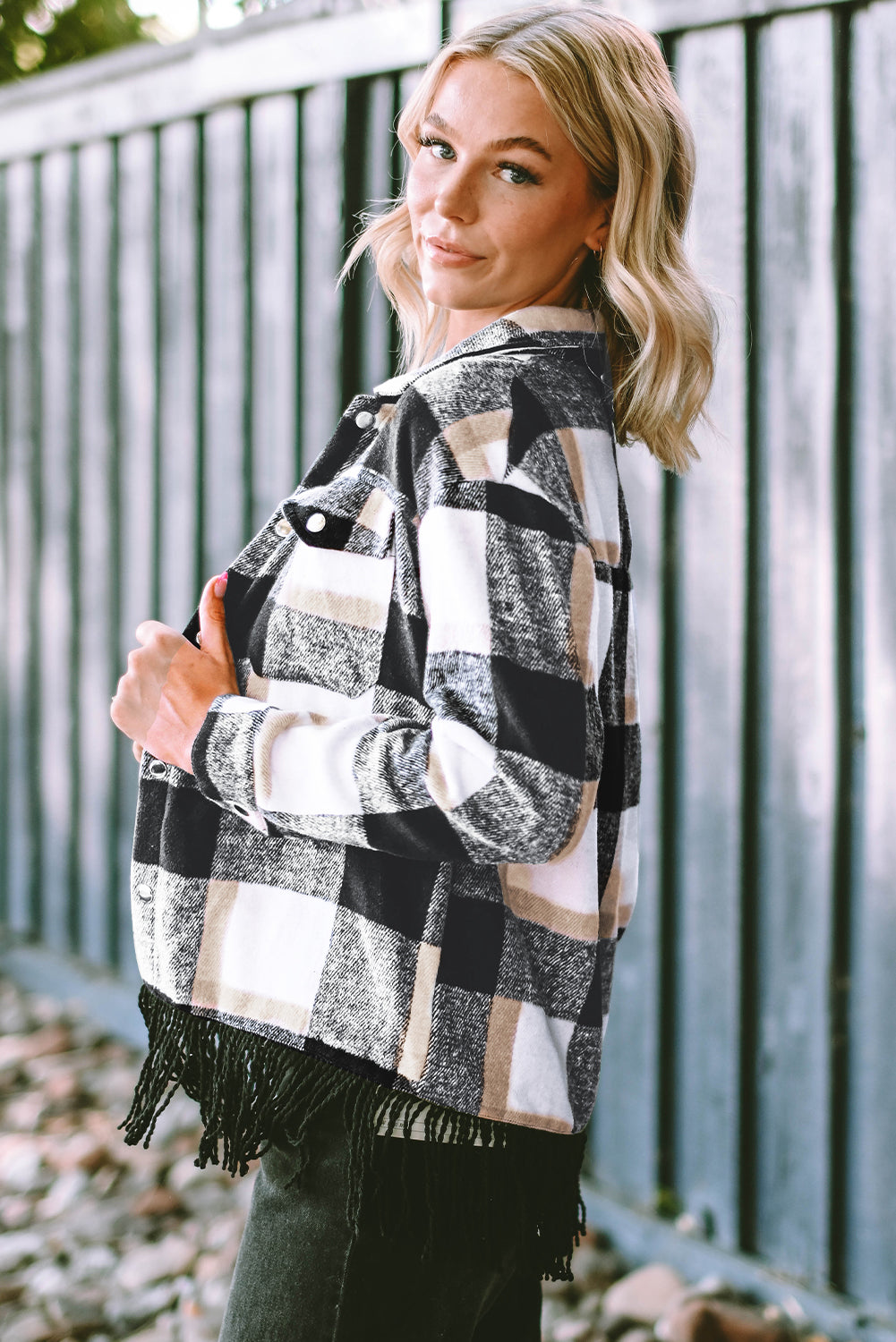 A stylish medium grey plaid jacket featuring a fringed hem, metal snap buttons, and two chest pockets, perfect for layering.