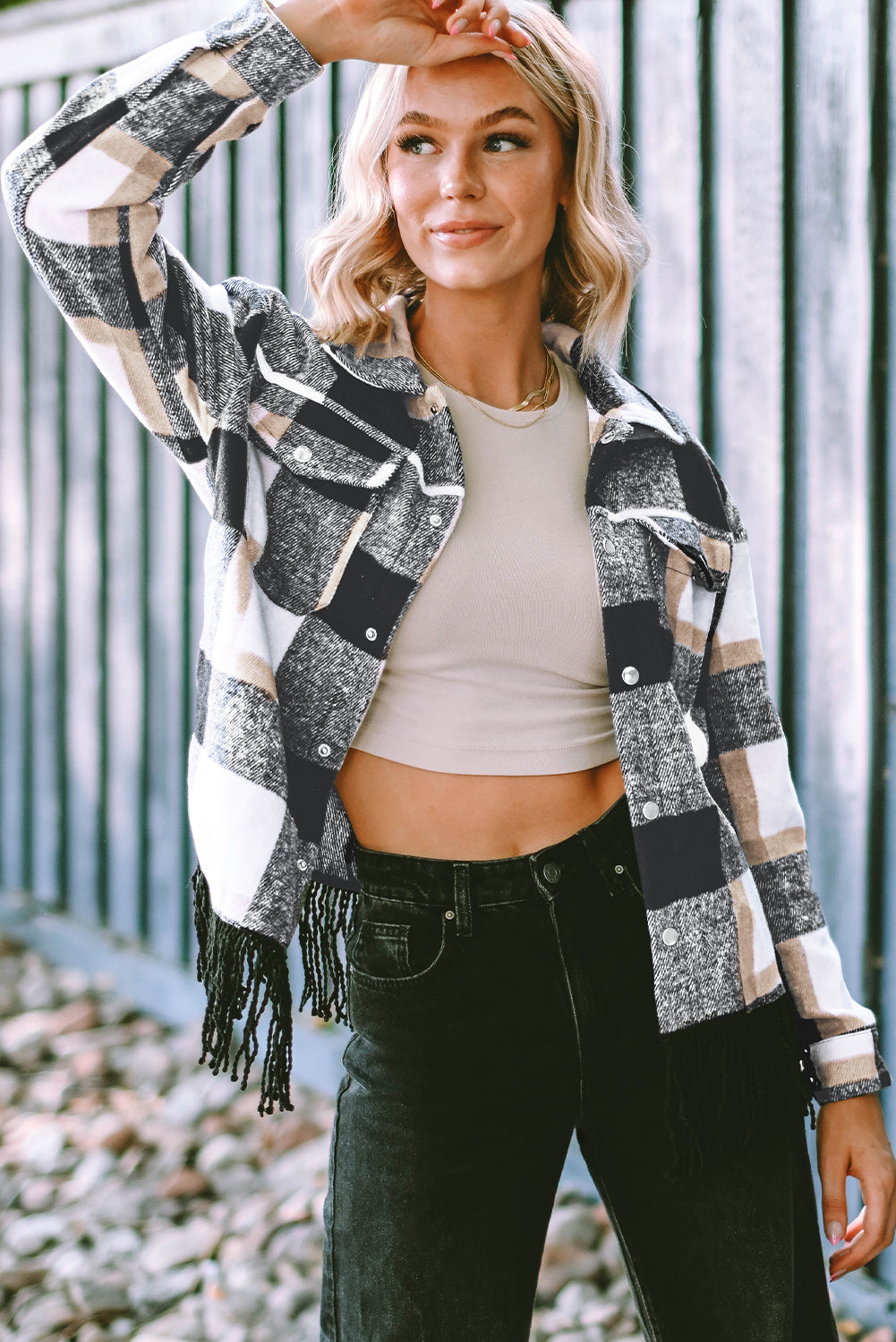 A stylish medium grey plaid jacket featuring a fringed hem, metal snap buttons, and two chest pockets, perfect for layering.