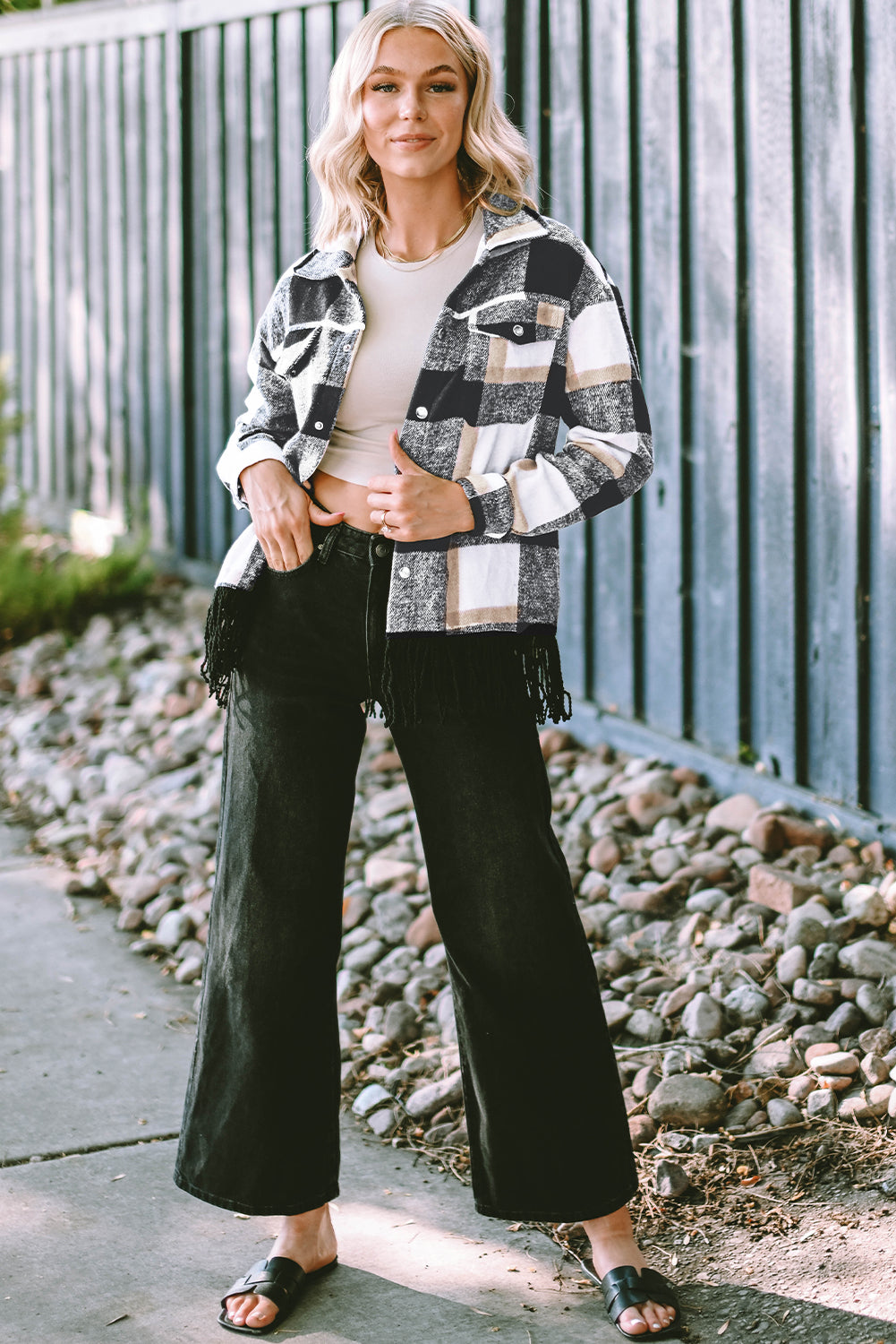 A stylish medium grey plaid jacket featuring a fringed hem, metal snap buttons, and two chest pockets, perfect for layering.