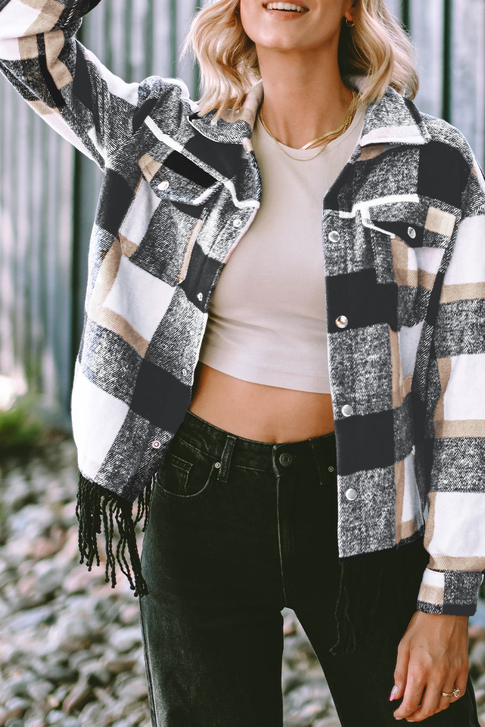 A stylish medium grey plaid jacket featuring a fringed hem, metal snap buttons, and two chest pockets, perfect for layering.