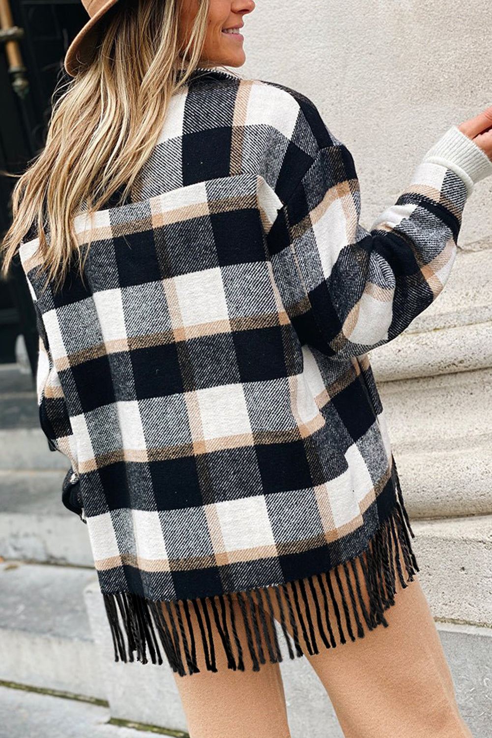 A stylish medium grey plaid jacket featuring a fringed hem, metal snap buttons, and two chest pockets, perfect for layering.