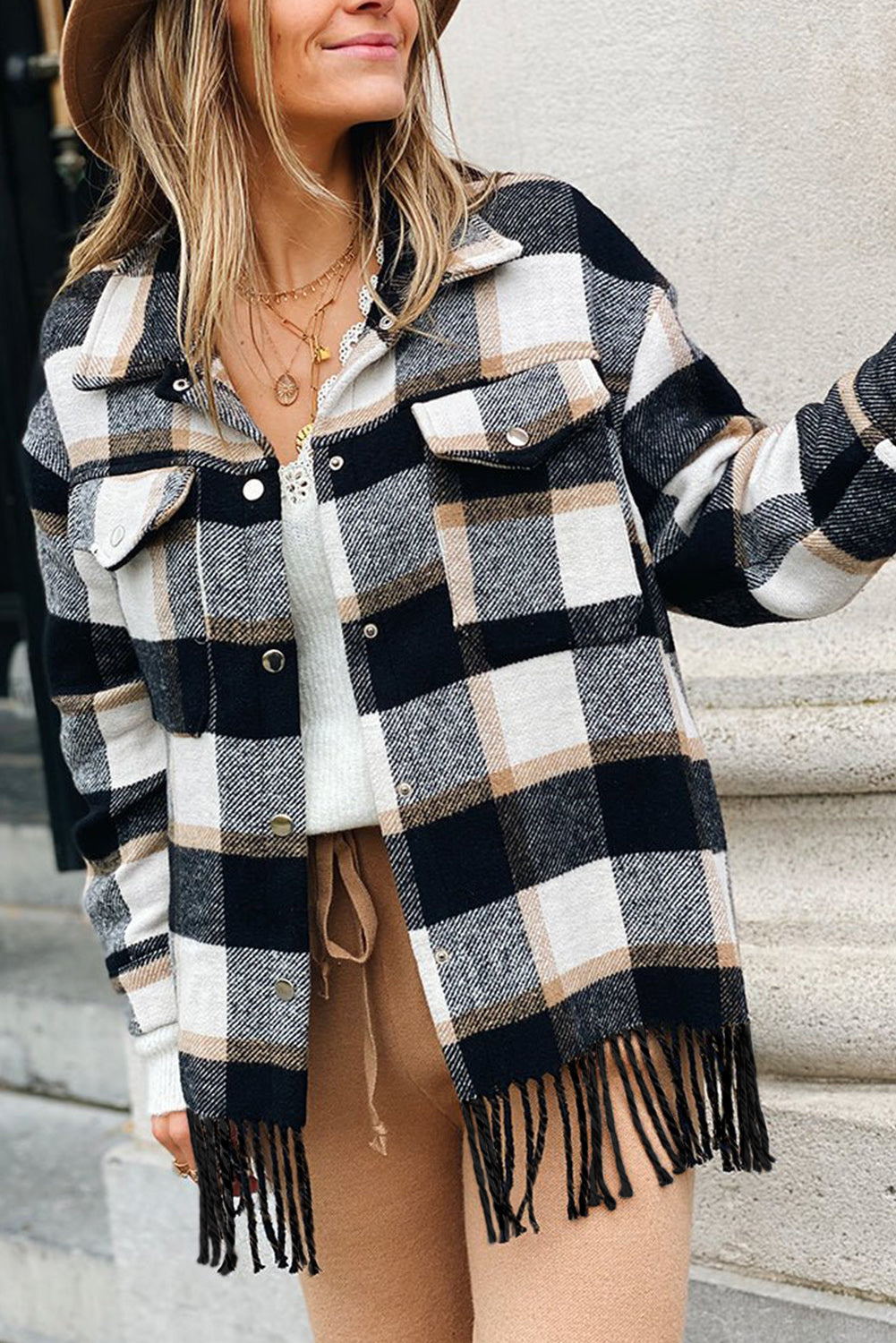 A stylish medium grey plaid jacket featuring a fringed hem, metal snap buttons, and two chest pockets, perfect for layering.