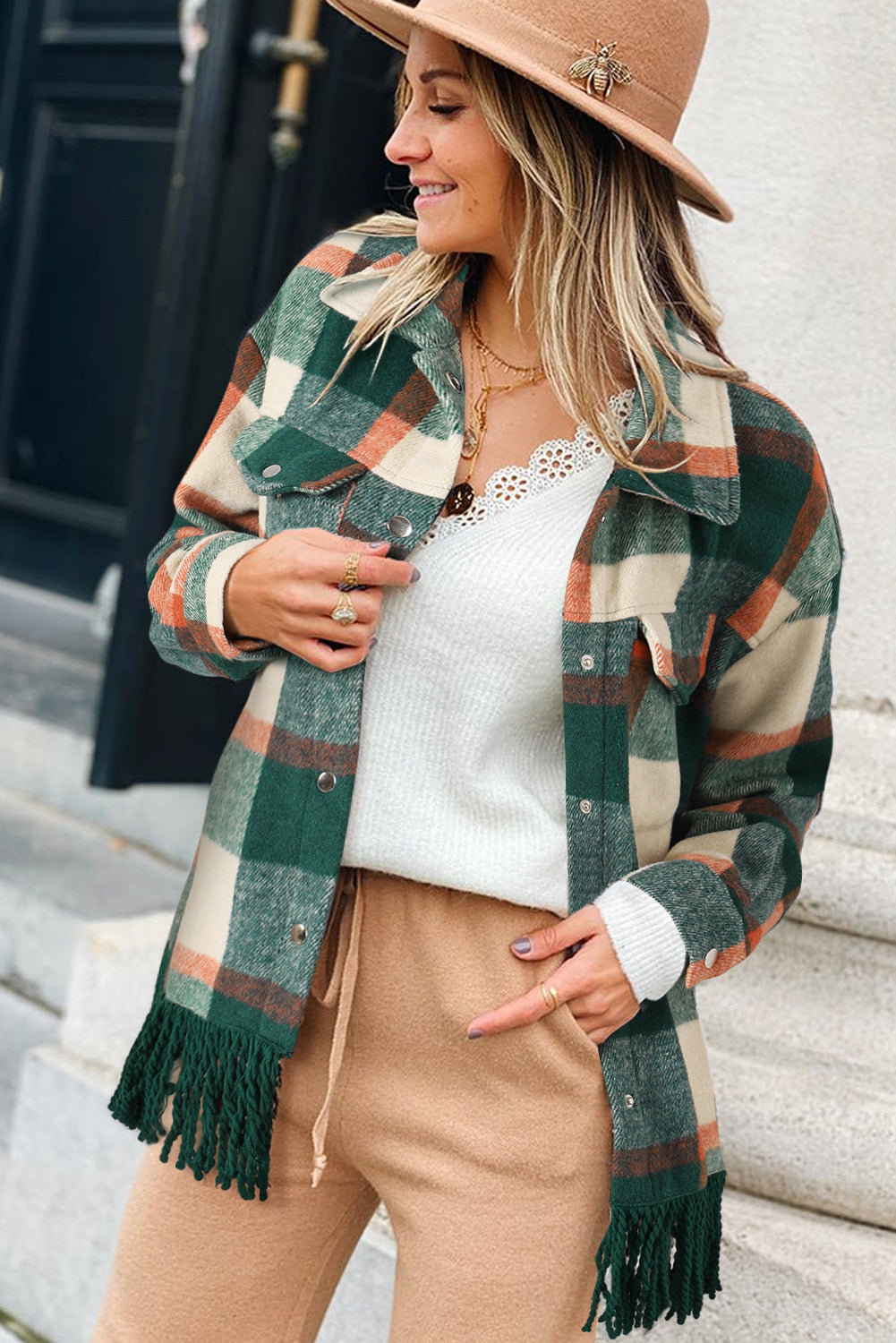 A stylish medium grey plaid jacket featuring a fringed hem, metal snap buttons, and two chest pockets, perfect for layering.