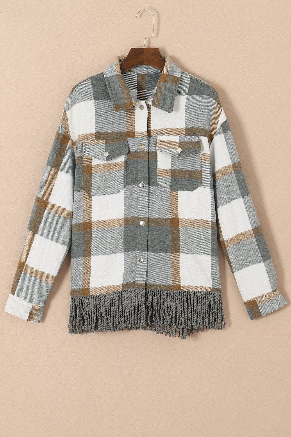 A stylish medium grey plaid jacket featuring a fringed hem, metal snap buttons, and two chest pockets, perfect for layering.