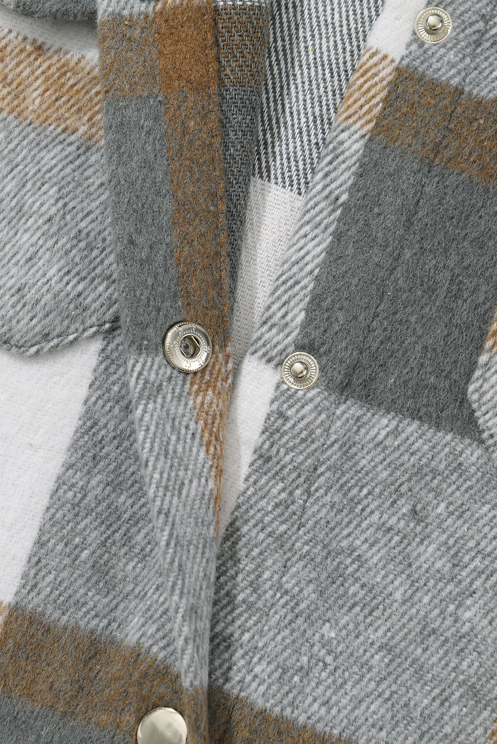 A stylish medium grey plaid jacket featuring a fringed hem, metal snap buttons, and two chest pockets, perfect for layering.