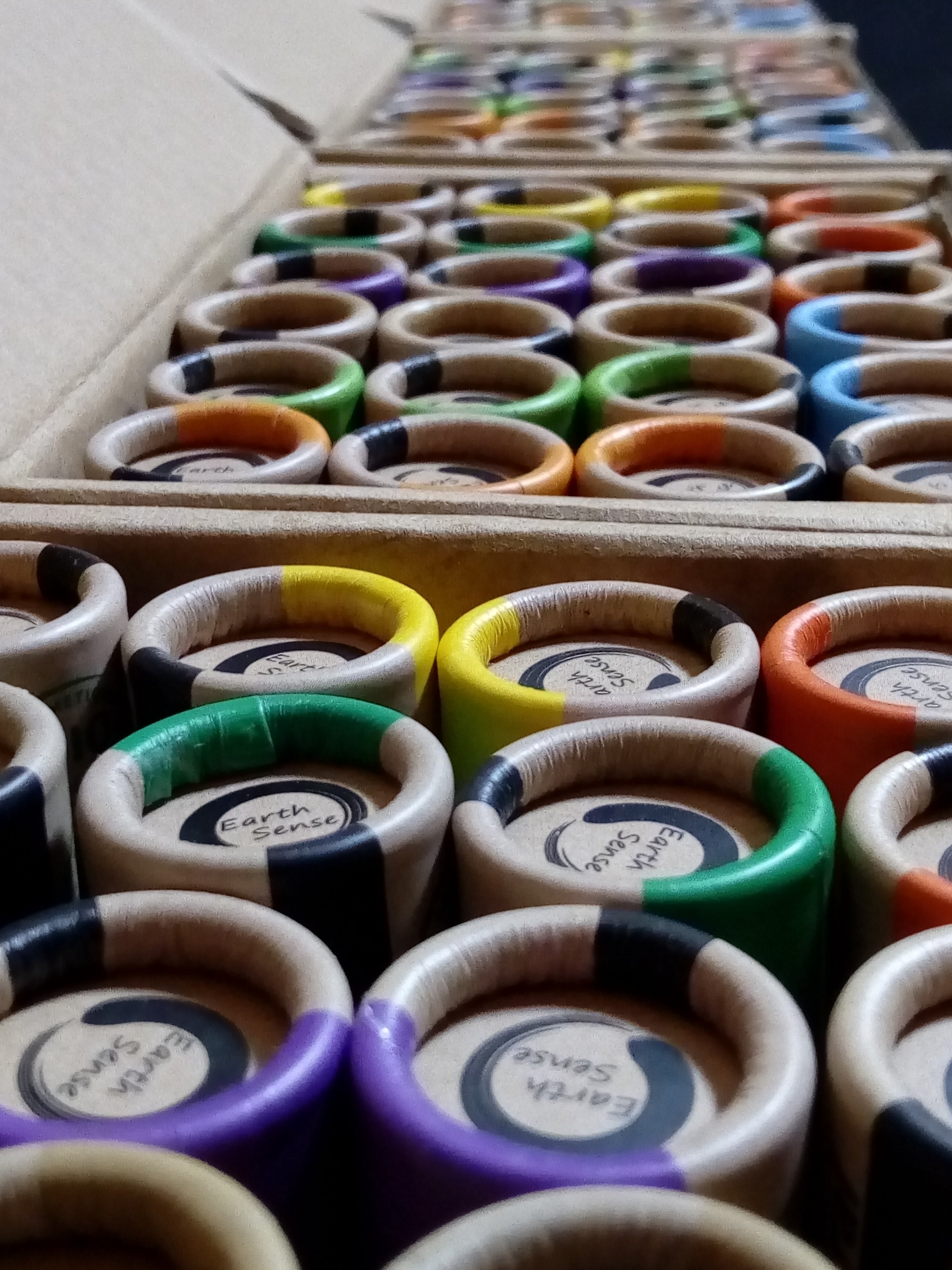 A colorful display of 30 x 15ml lip balms in various flavors including eucalyptus, rose, grapefruit, and more, arranged neatly in a bundle.