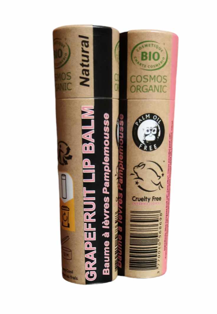 A collection of 30 Organic Pink Grapefruit Lip Balms in 15ml tubes, showcasing their vibrant packaging and natural ingredients.