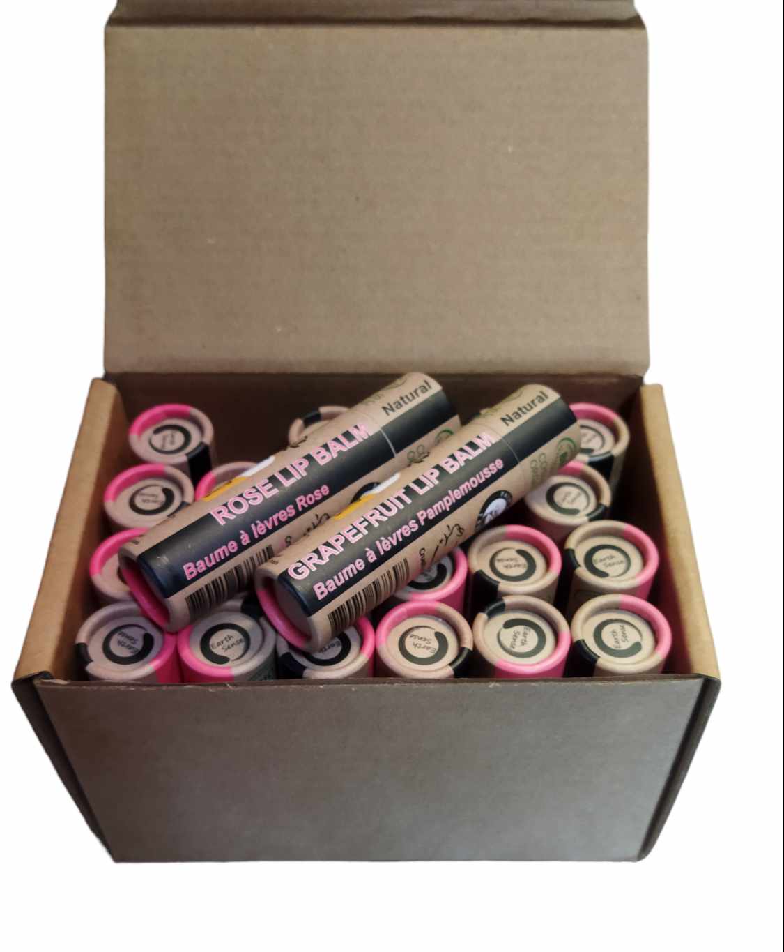 A collection of 30 tubes of 15ml Organic Rose Lip Balm, showcasing their eco-friendly packaging and natural ingredients.