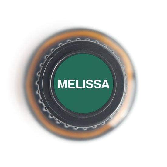 A 5ml bottle of Melissa Pure Essential Oil, showcasing its elegant design and label, with a background of fresh lemon balm leaves.