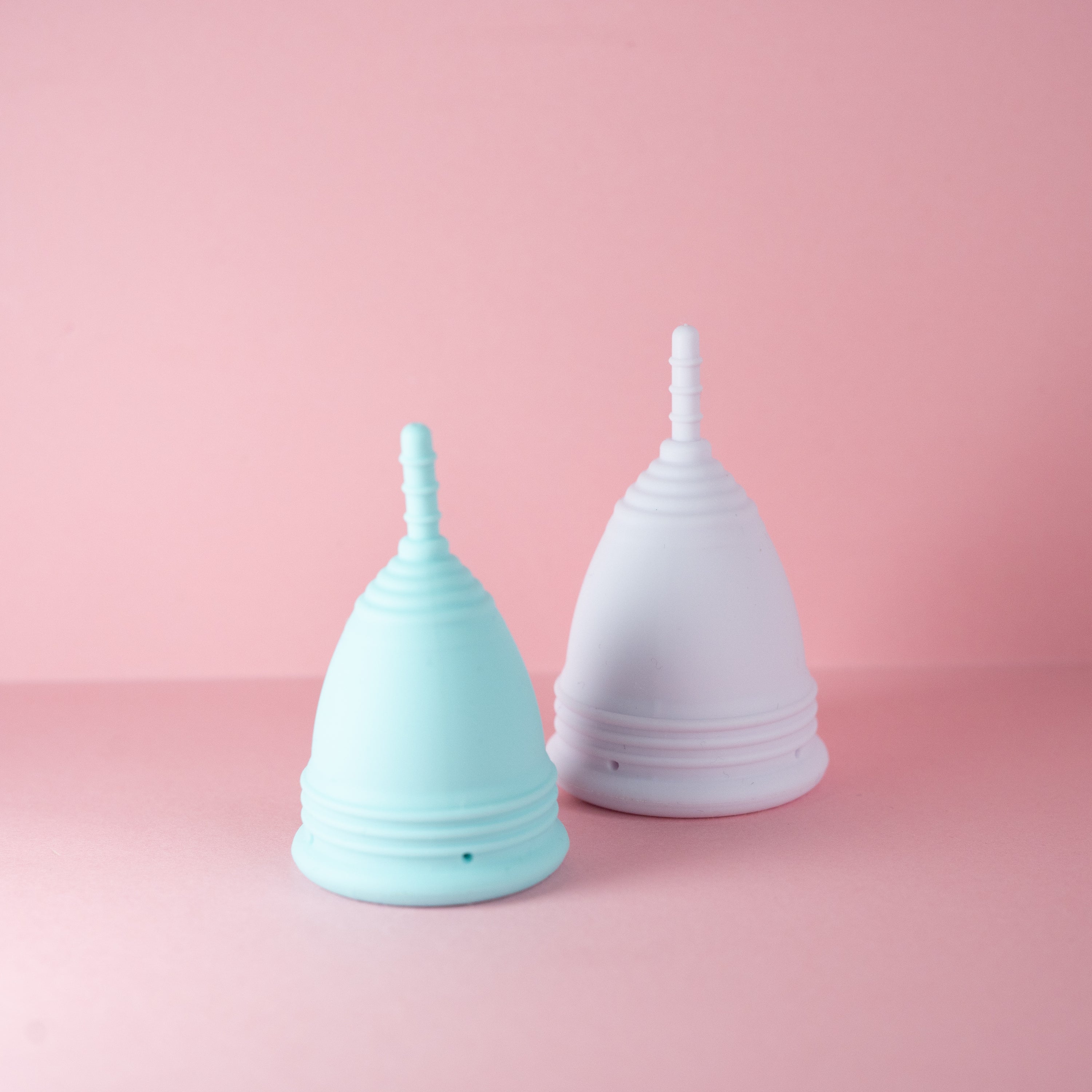 Menstrual Cup Set including two reusable cups, a travel pouch, and a steriliser cup, designed for sustainable period care.