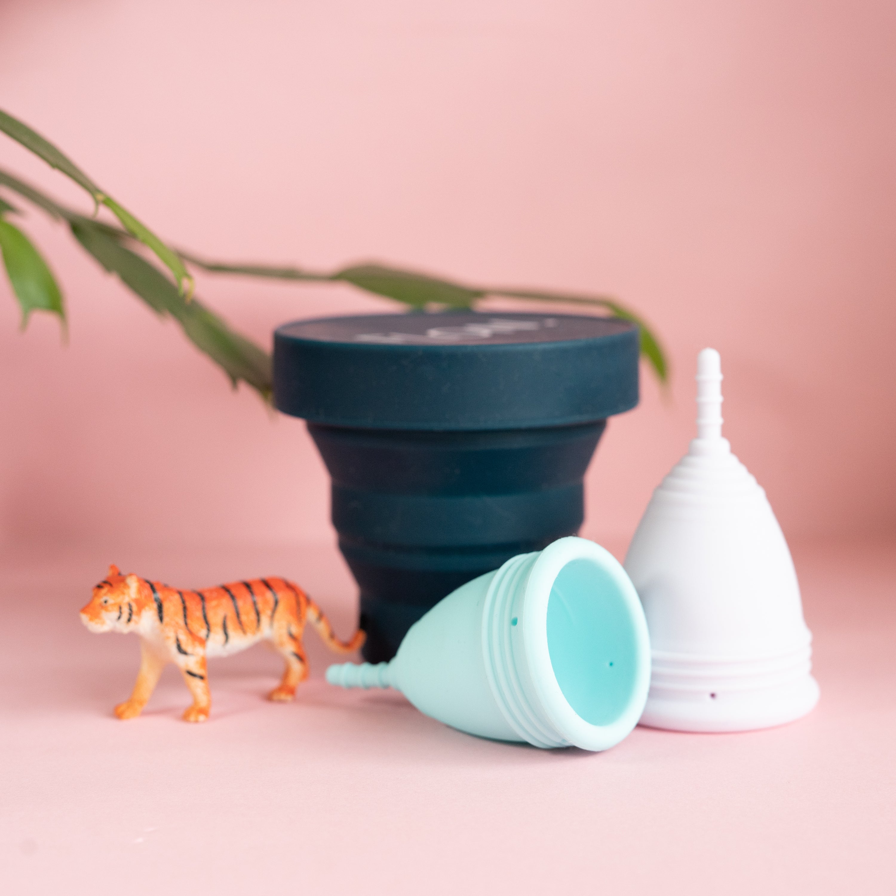 Menstrual Cup Set including two reusable cups, a travel pouch, and a steriliser cup, designed for sustainable period care.