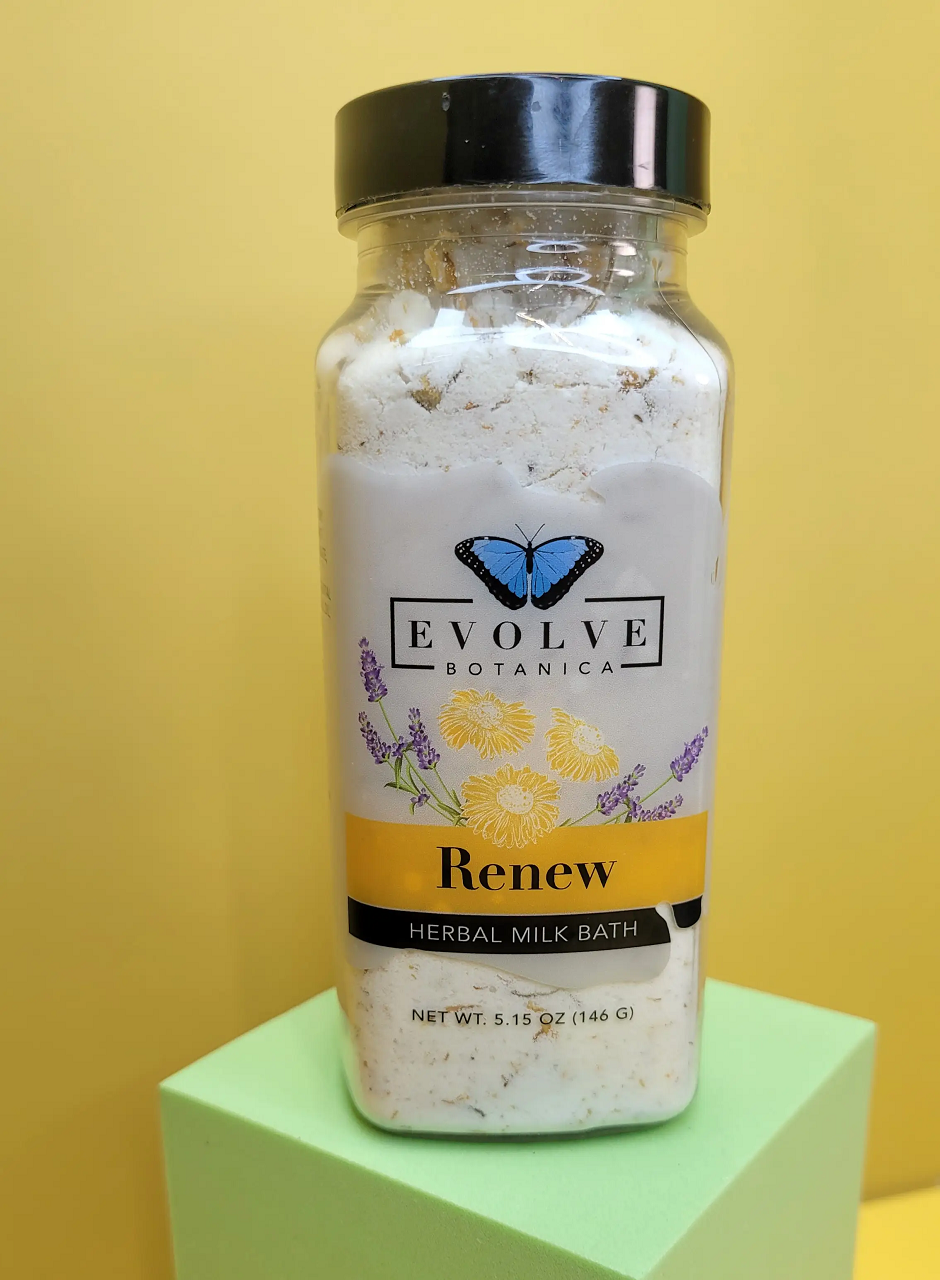 A luxurious package of Milk Bath - Renew featuring herbal ingredients like coconut milk, lavender, and chamomile flowers, perfect for a soothing bath experience.