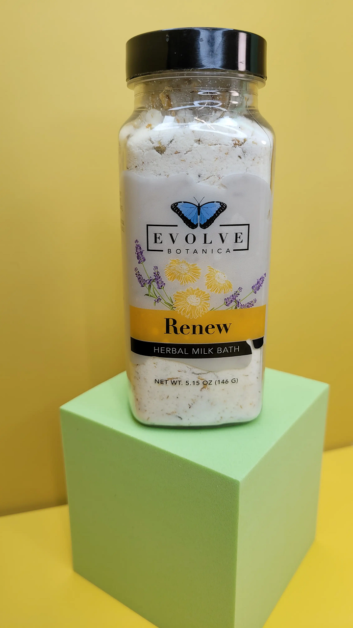 A luxurious package of Milk Bath - Renew featuring herbal ingredients like coconut milk, lavender, and chamomile flowers, perfect for a soothing bath experience.