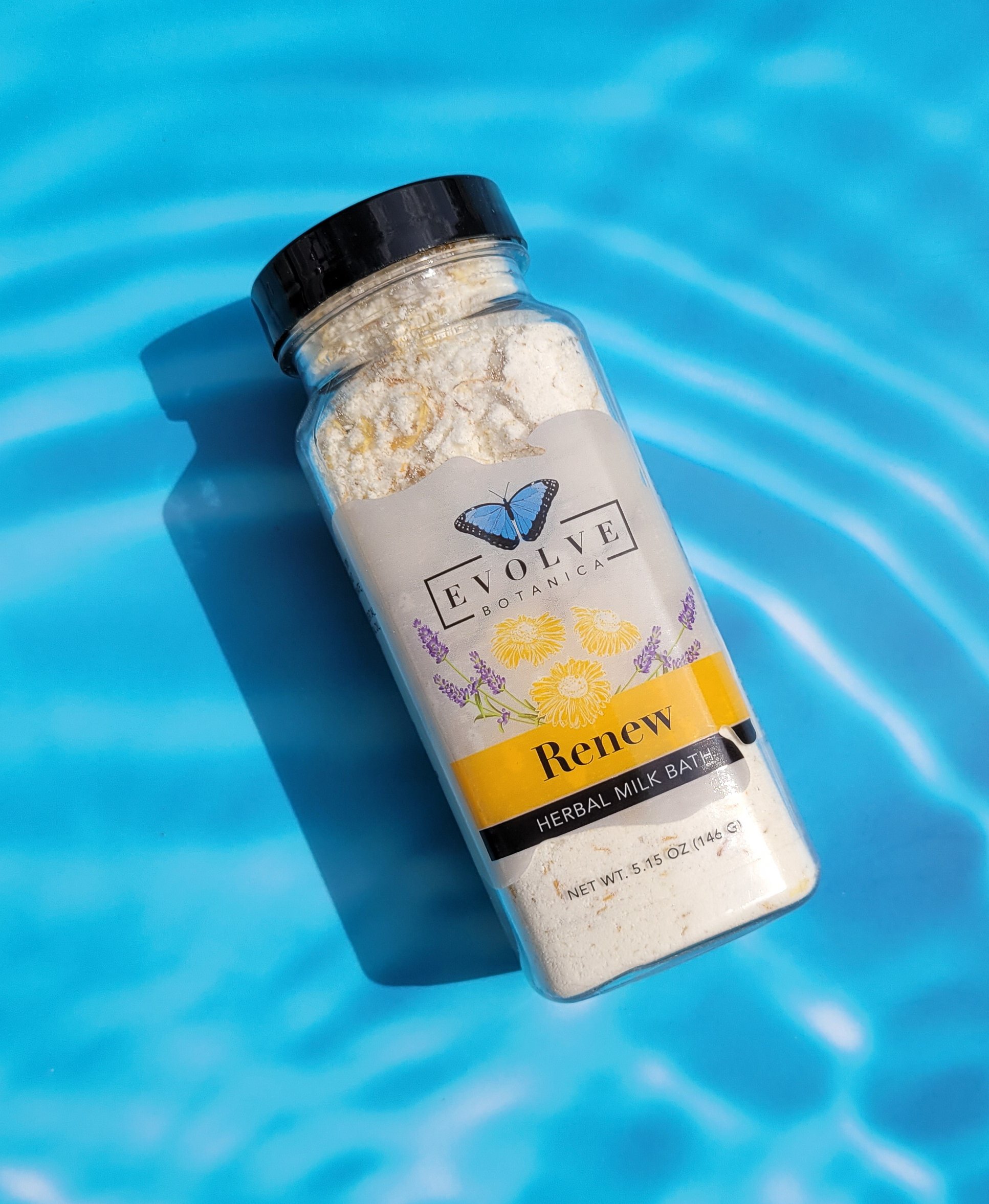 A luxurious package of Milk Bath - Renew featuring herbal ingredients like coconut milk, lavender, and chamomile flowers, perfect for a soothing bath experience.