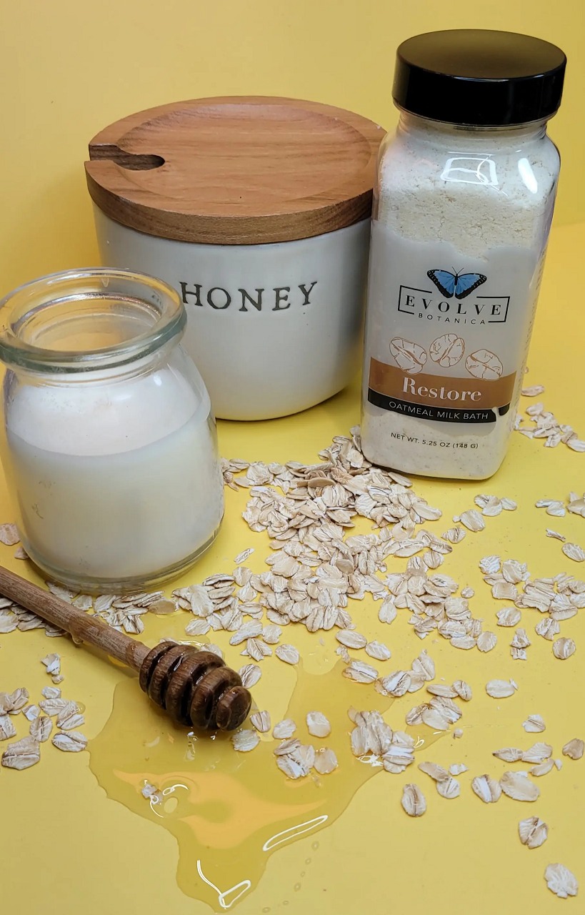 A luxurious Milk Bath - Restore package featuring oatmeal and lavender blend, with ingredients like coconut milk and colloidal oatmeal.