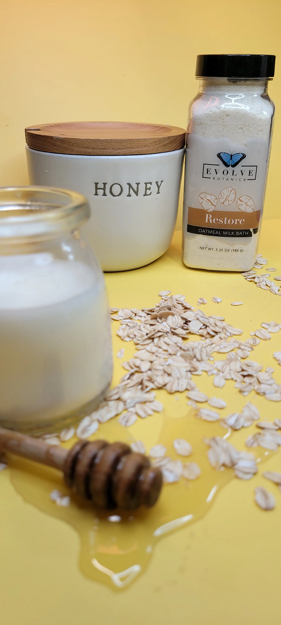 A luxurious Milk Bath - Restore package featuring oatmeal and lavender blend, with ingredients like coconut milk and colloidal oatmeal.