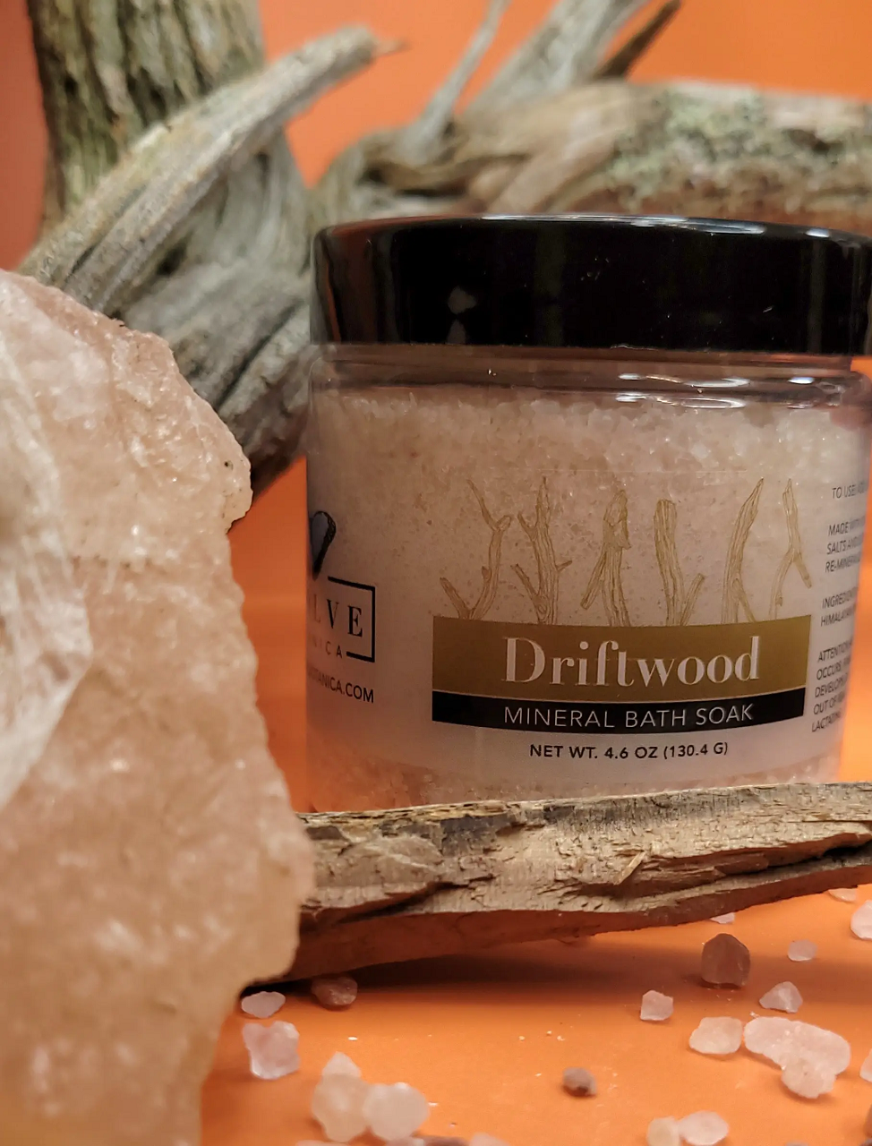 A jar of Mineral Soak - Driftwood bath salt, featuring a blend of Himalayan pink salt, Dead Sea salts, and Pacific solar salts, with a calming driftwood fragrance.