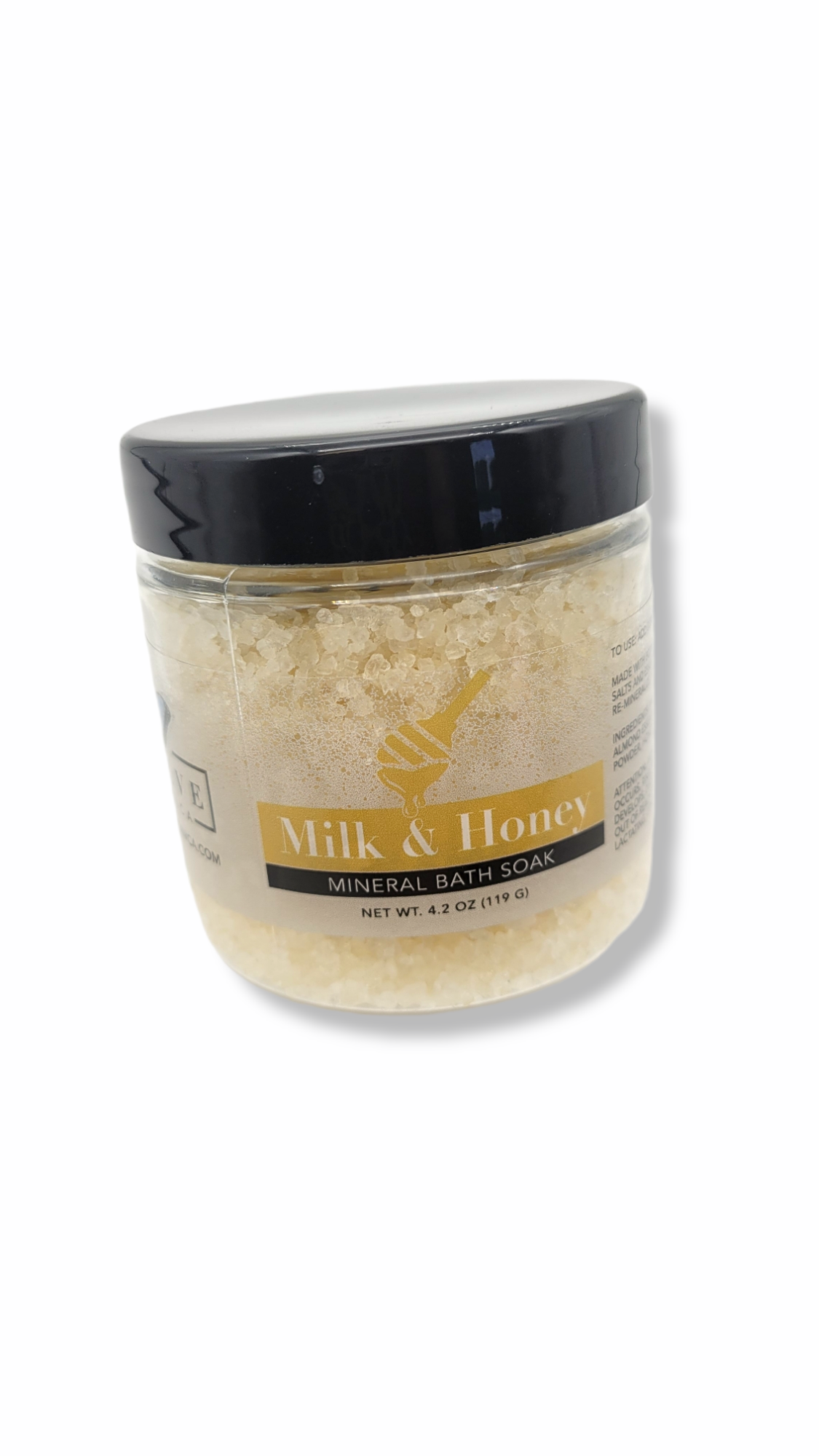 A jar of Mineral Soak - Milk & Honey bath salt featuring a blend of natural ingredients, including Dead Sea salts and honey powder.