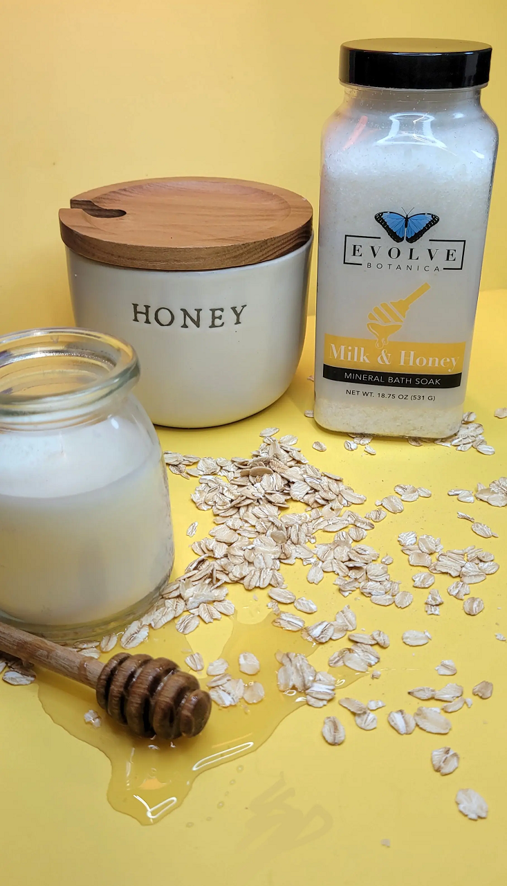 A jar of Mineral Soak - Milk & Honey bath salt, showcasing its natural ingredients and rich texture.