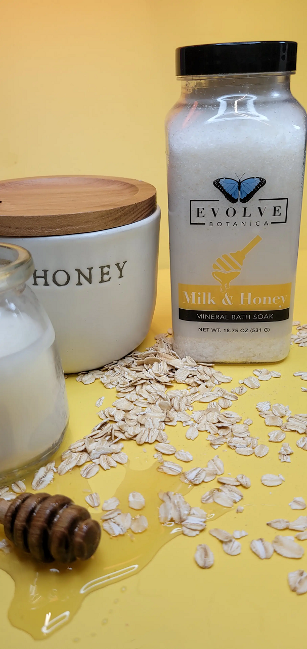 A jar of Mineral Soak - Milk & Honey bath salt, showcasing its natural ingredients and rich texture.