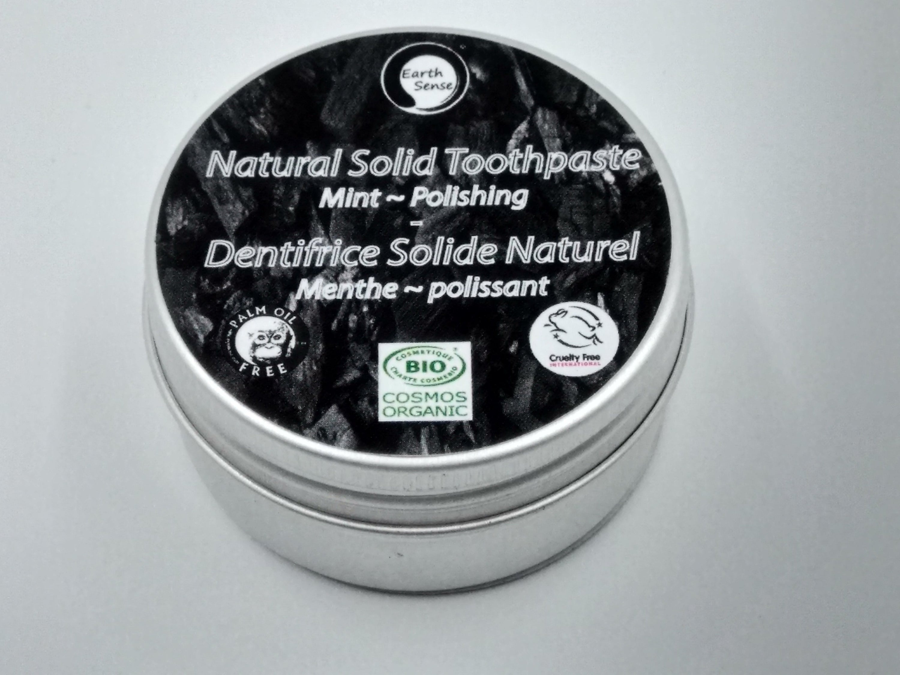 Four 40g tins of Natural Organic Certified Solid Toothpaste in mint flavor, packaged in recyclable aluminum tins.