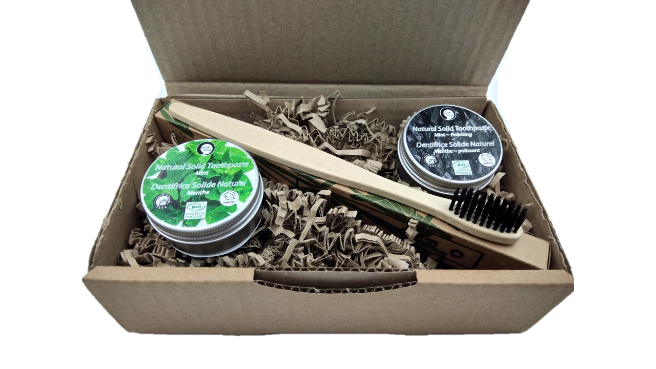 Four 40g tins of Natural Organic Certified Solid Toothpaste in mint flavor, packaged in recyclable aluminum tins.