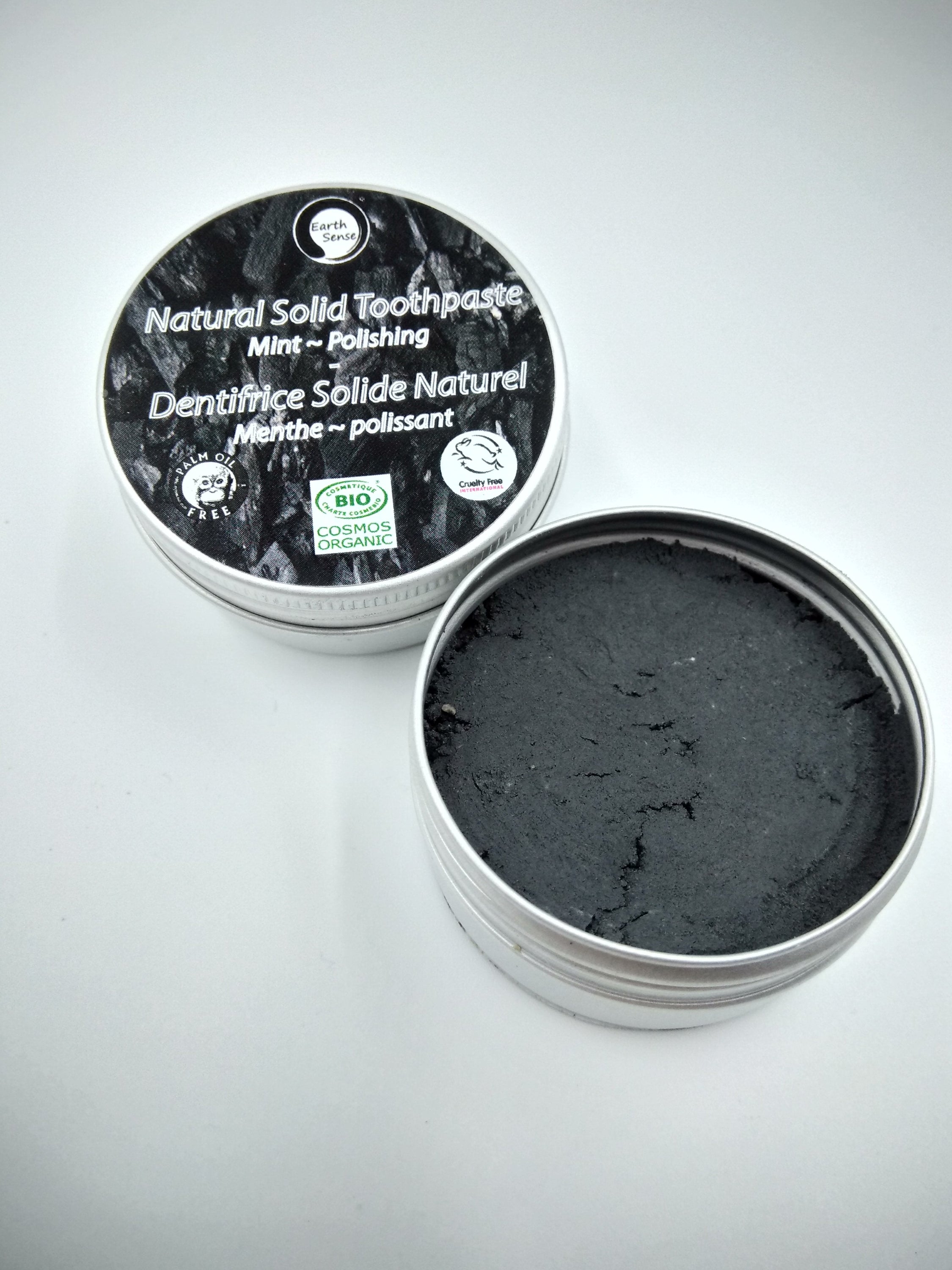 Four 40g tins of Natural Organic Certified Solid Toothpaste in mint flavor, packaged in recyclable aluminum tins.