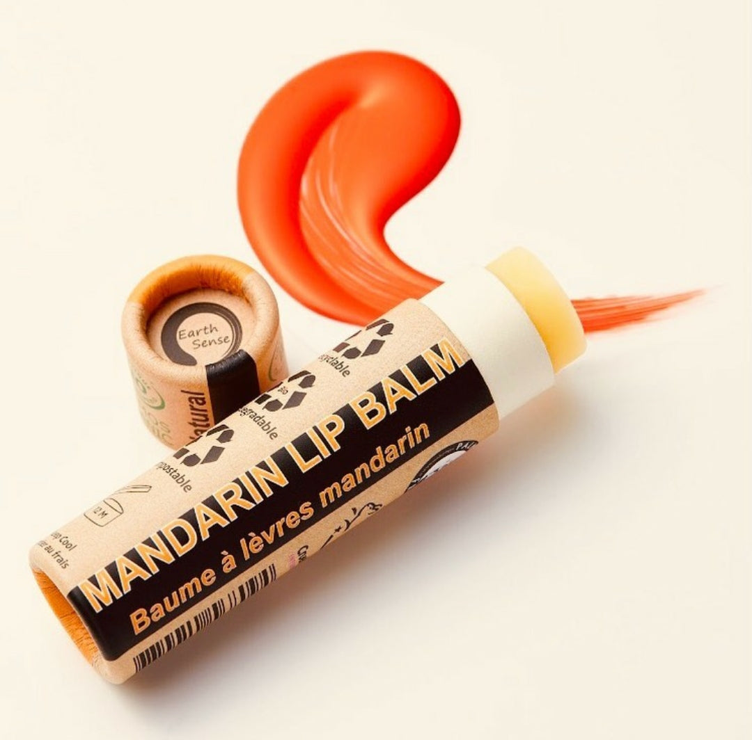 Four 15ml tubes of Organic Mandarin Lip Balm in eco-friendly packaging, showcasing natural ingredients and vibrant mandarin scent.