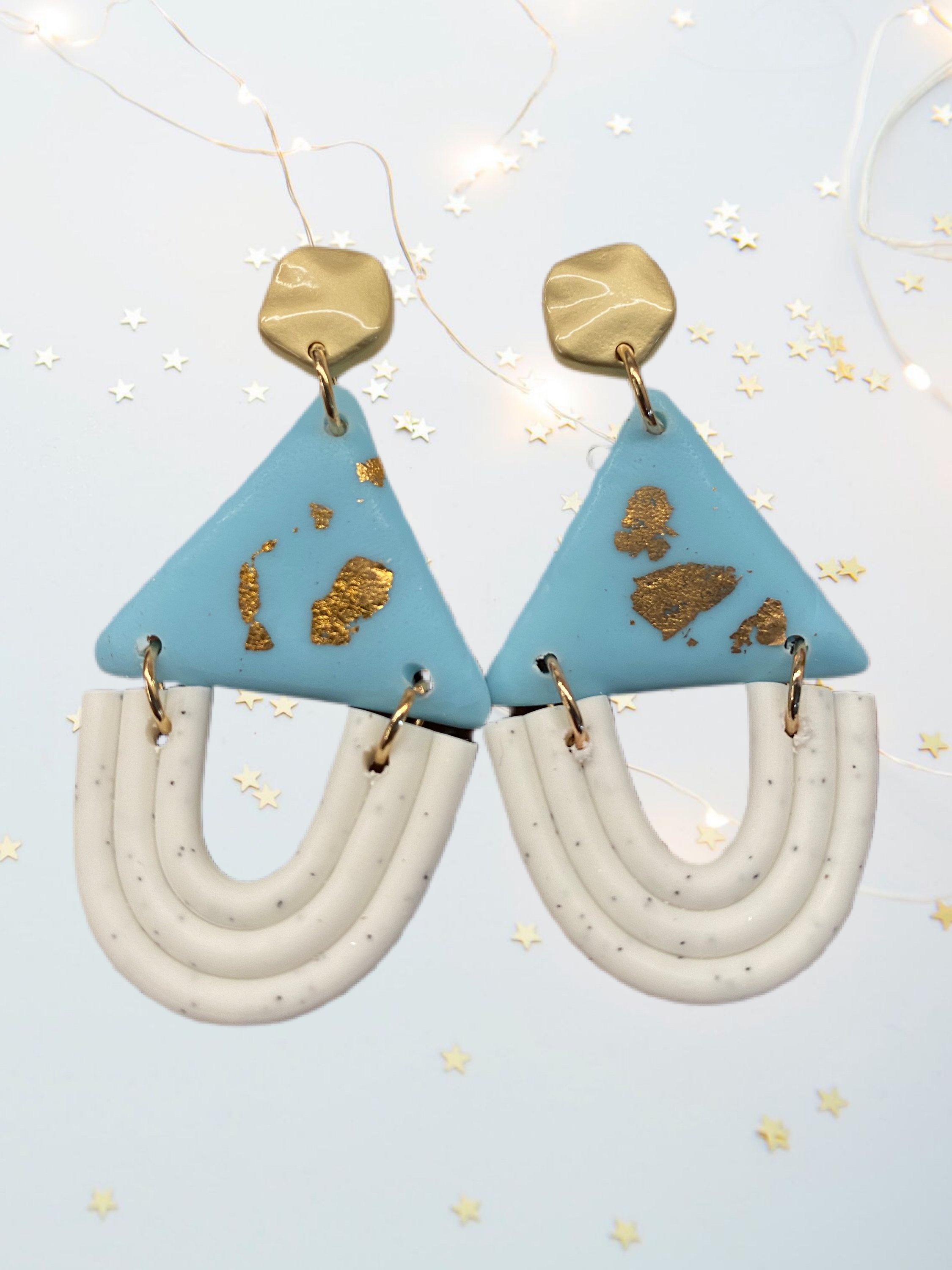 A pair of unique handcrafted modern clay earrings in vibrant colors, showcasing their lightweight and stylish design.