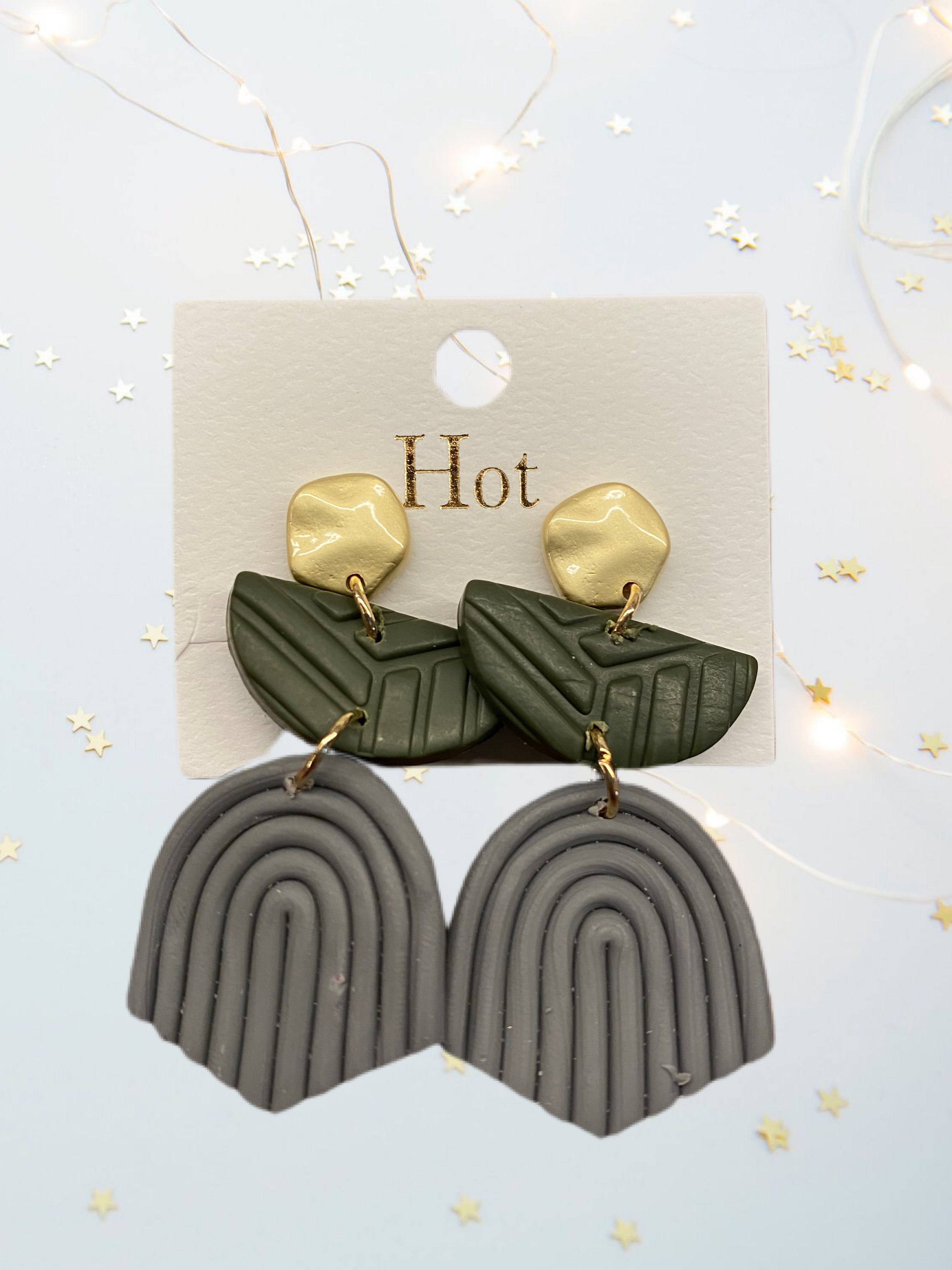 A pair of unique handcrafted modern clay earrings in vibrant colors, showcasing their lightweight and stylish design.