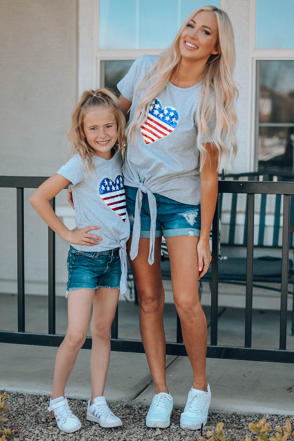 Mommy Patriotic Flag Sequin Heart Applique Knot Top featuring a heart-shaped flag design, soft gray fabric, and stylish knot hem.