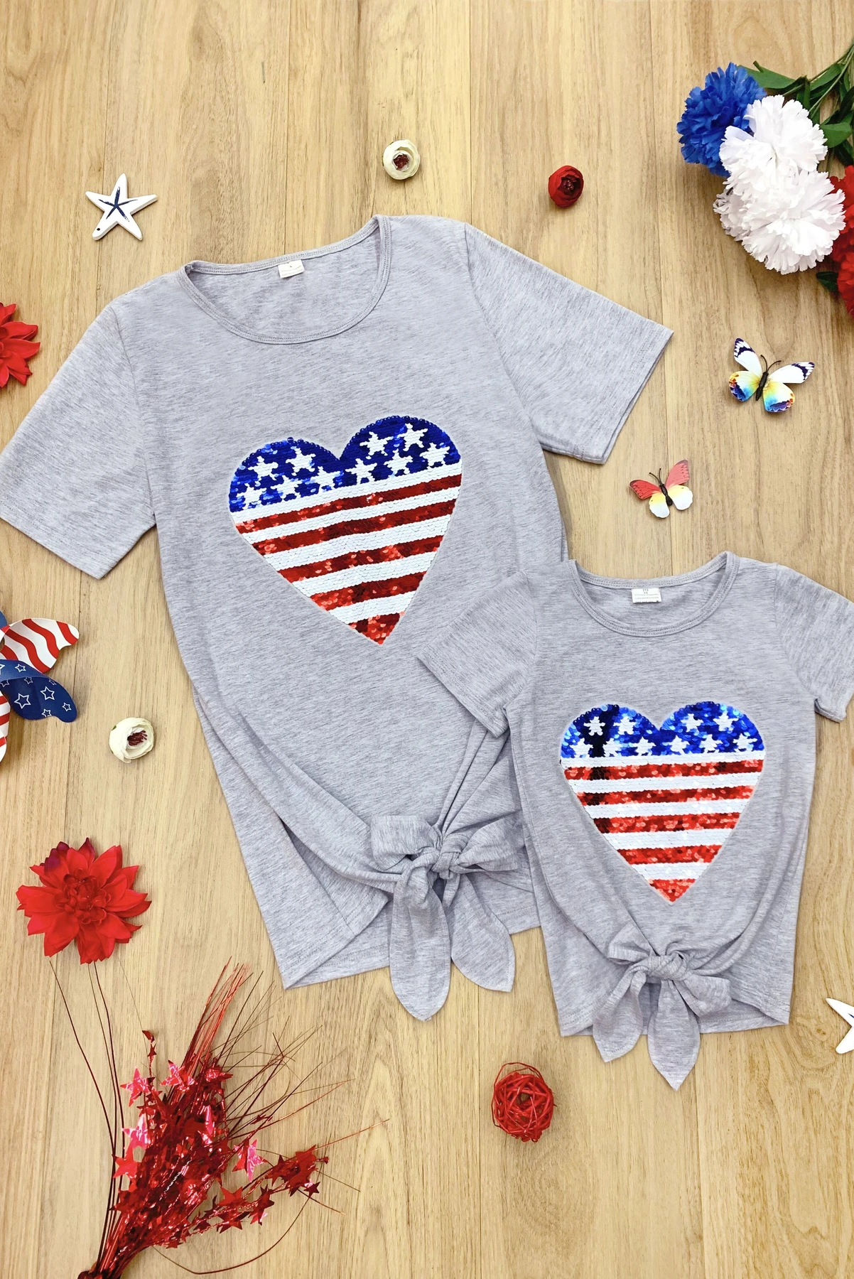 Mommy Patriotic Flag Sequin Heart Applique Knot Top featuring a heart-shaped flag design, soft gray fabric, and stylish knot hem.