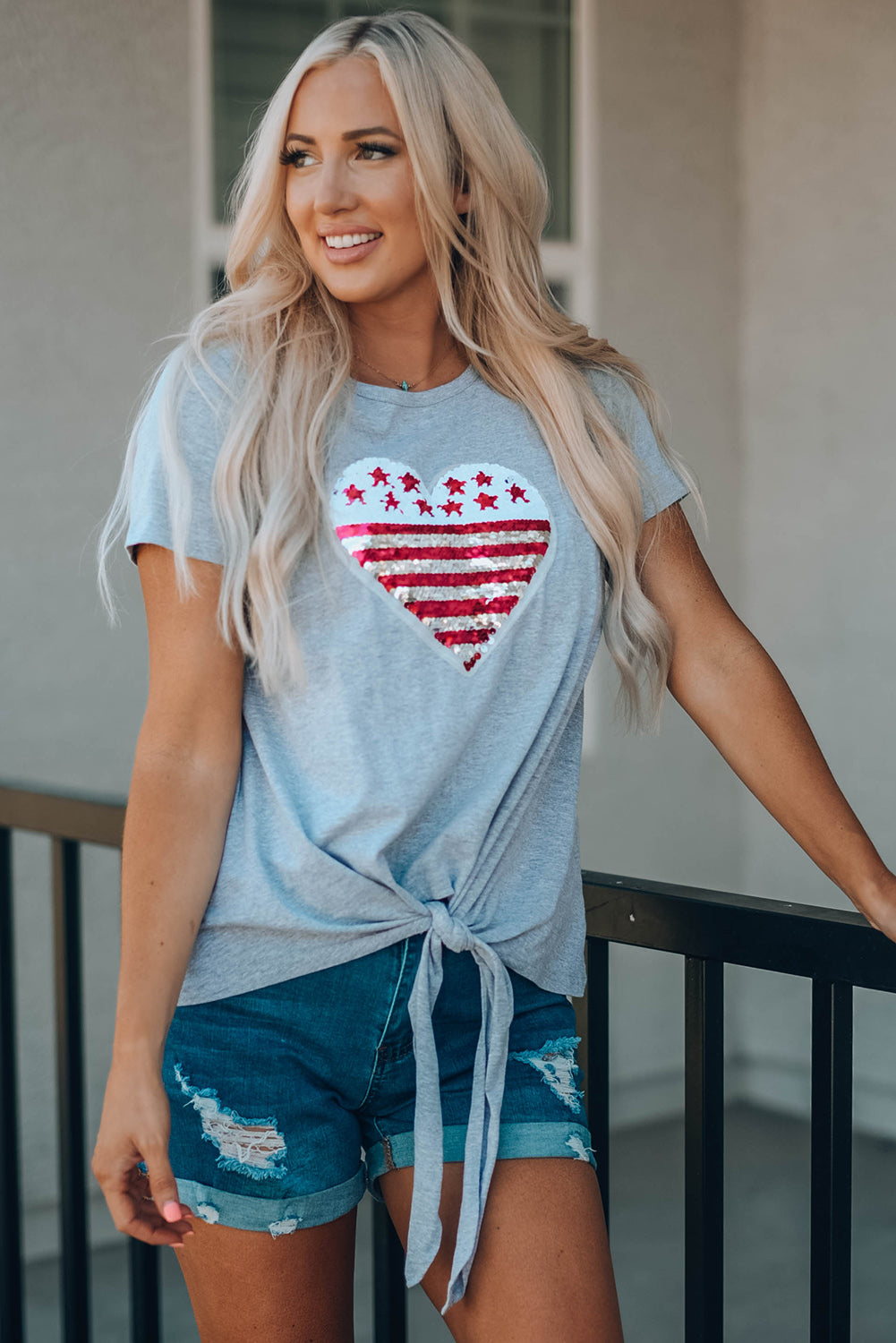 Mommy Patriotic Flag Sequin Heart Applique Knot Top featuring a heart-shaped flag design, soft gray fabric, and stylish knot hem.