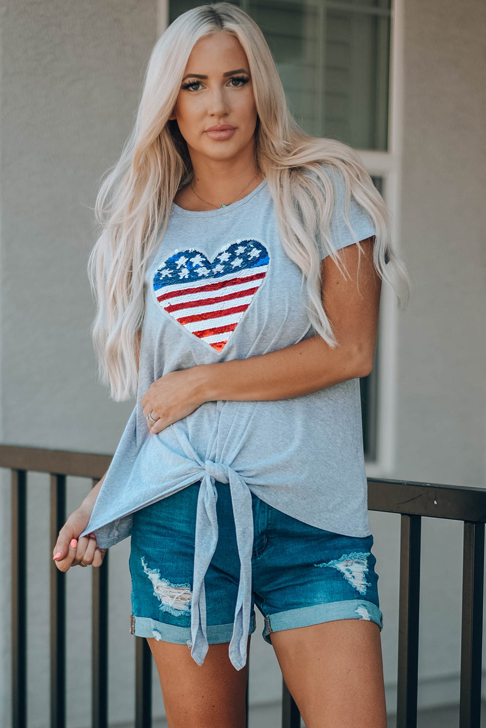 Mommy Patriotic Flag Sequin Heart Applique Knot Top featuring a heart-shaped flag design, soft gray fabric, and stylish knot hem.