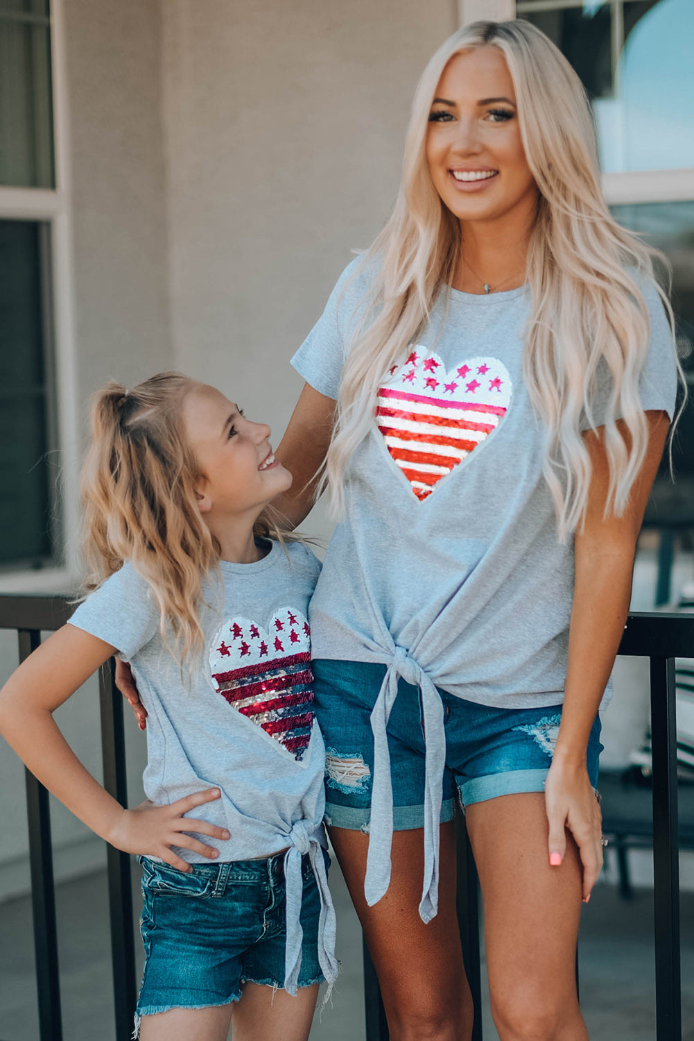 Mommy Patriotic Flag Sequin Heart Applique Knot Top featuring a heart-shaped flag design, soft gray fabric, and stylish knot hem.