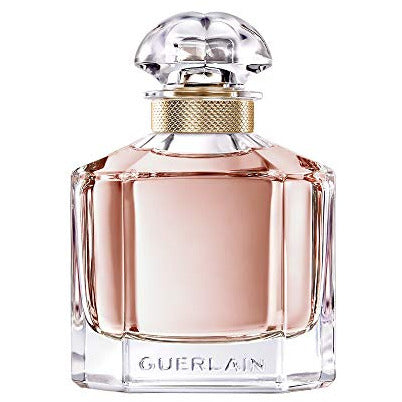 Guerlain Mon Eau de Parfum bottle elegantly displayed with floral accents.