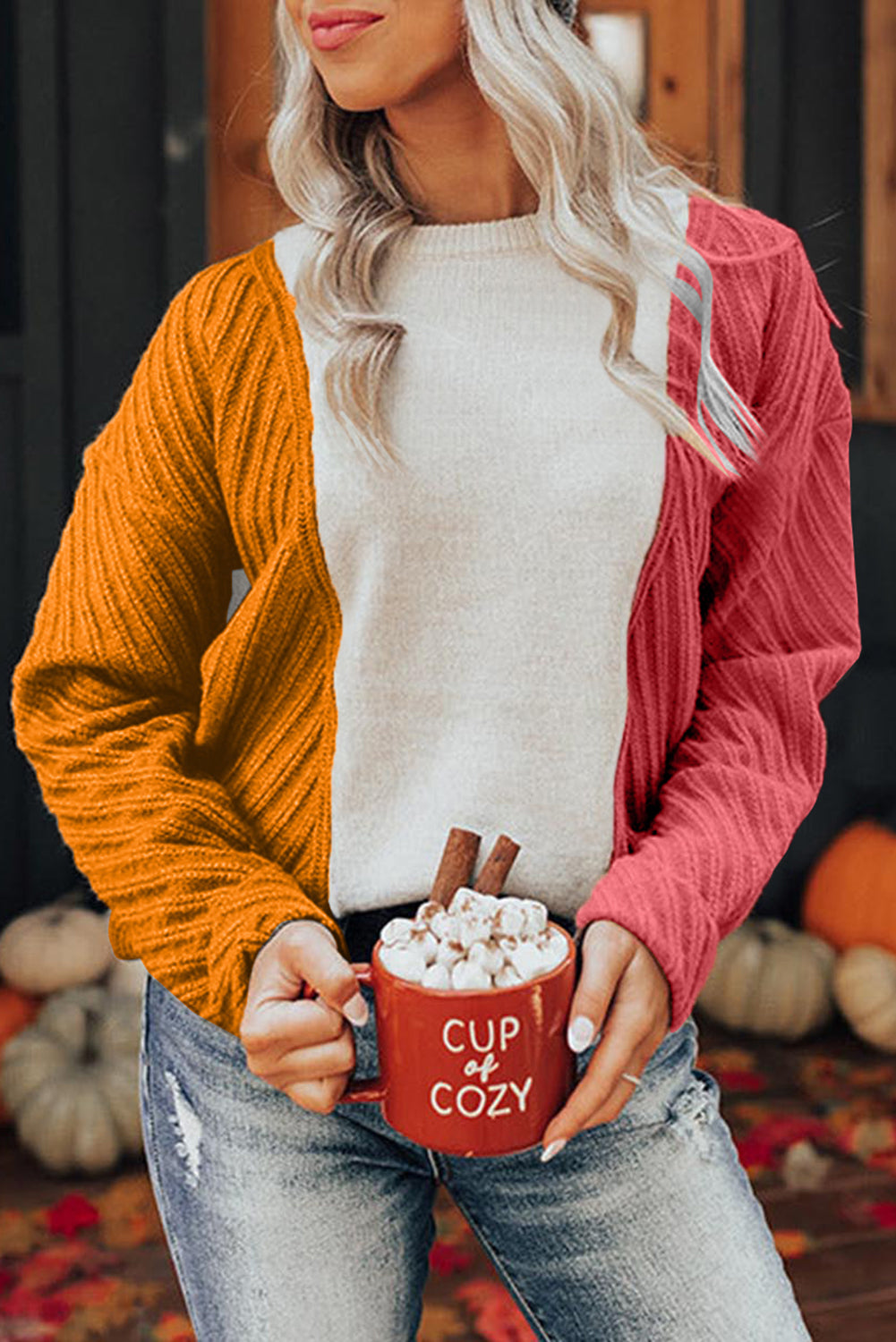 A stylish multicolor colorblock textured drop shoulder sweater displayed on a mannequin, showcasing its unique design and cozy fabric.