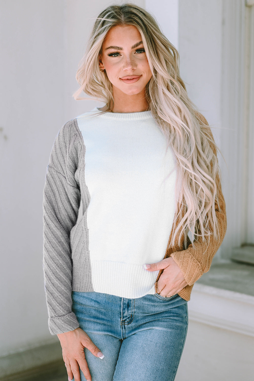 A stylish multicolor colorblock textured drop shoulder sweater displayed on a mannequin, showcasing its unique design and cozy fabric.