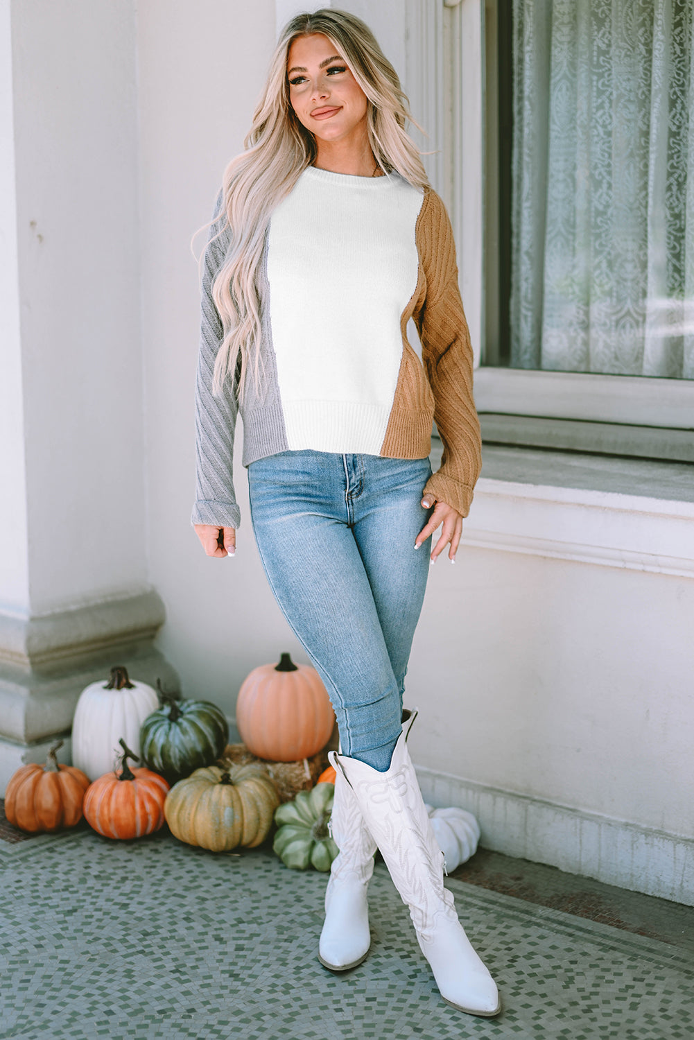 A stylish multicolor colorblock textured drop shoulder sweater displayed on a mannequin, showcasing its unique design and cozy fabric.