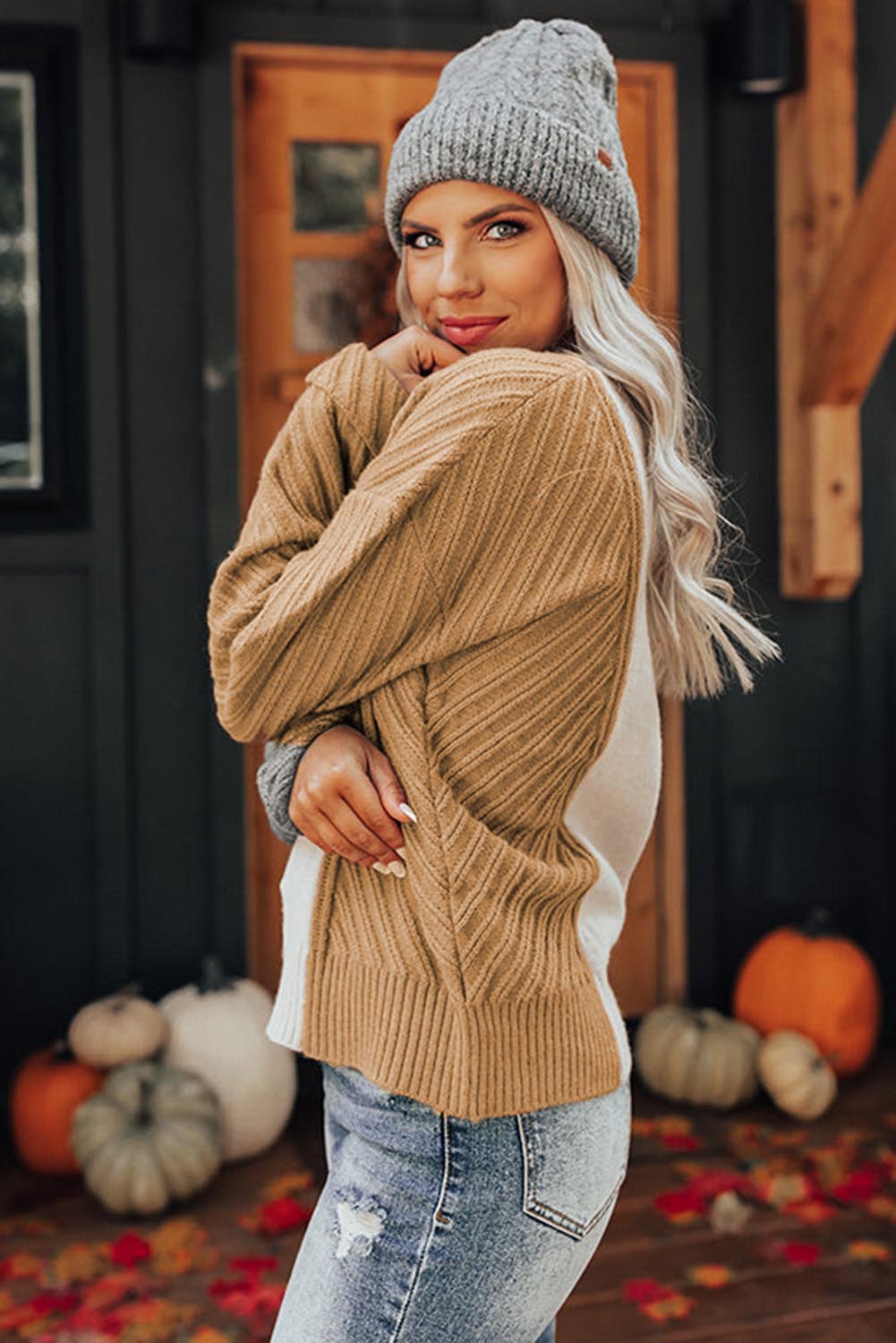 A stylish multicolor colorblock textured drop shoulder sweater displayed on a mannequin, showcasing its unique design and cozy fabric.