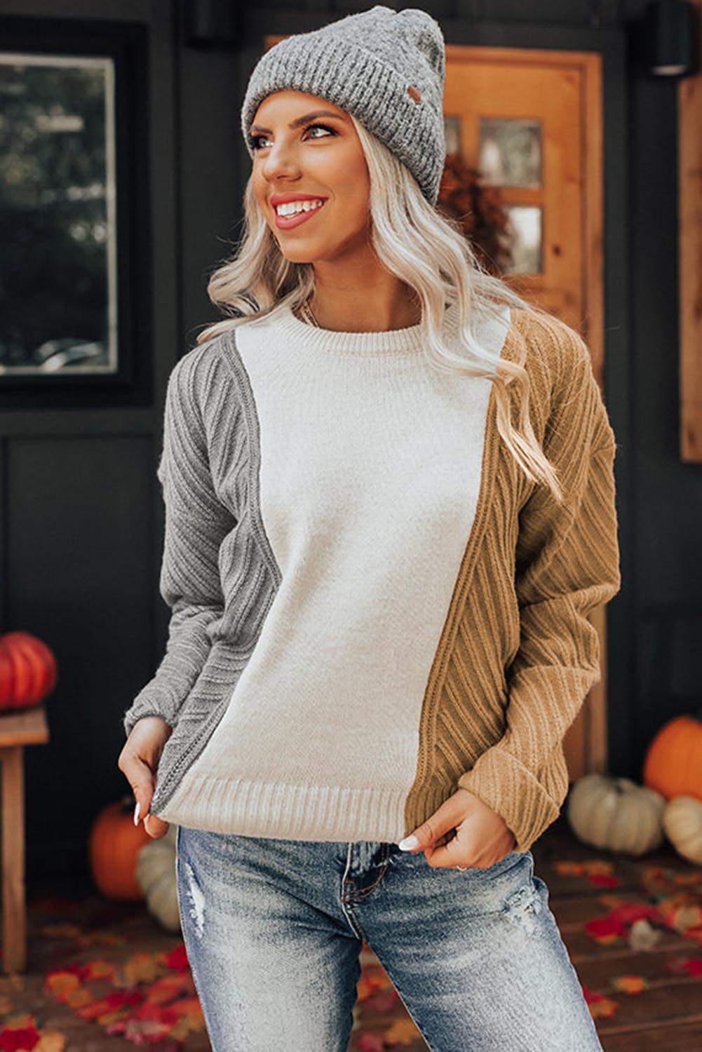 A stylish multicolor colorblock textured drop shoulder sweater displayed on a mannequin, showcasing its unique design and cozy fabric.