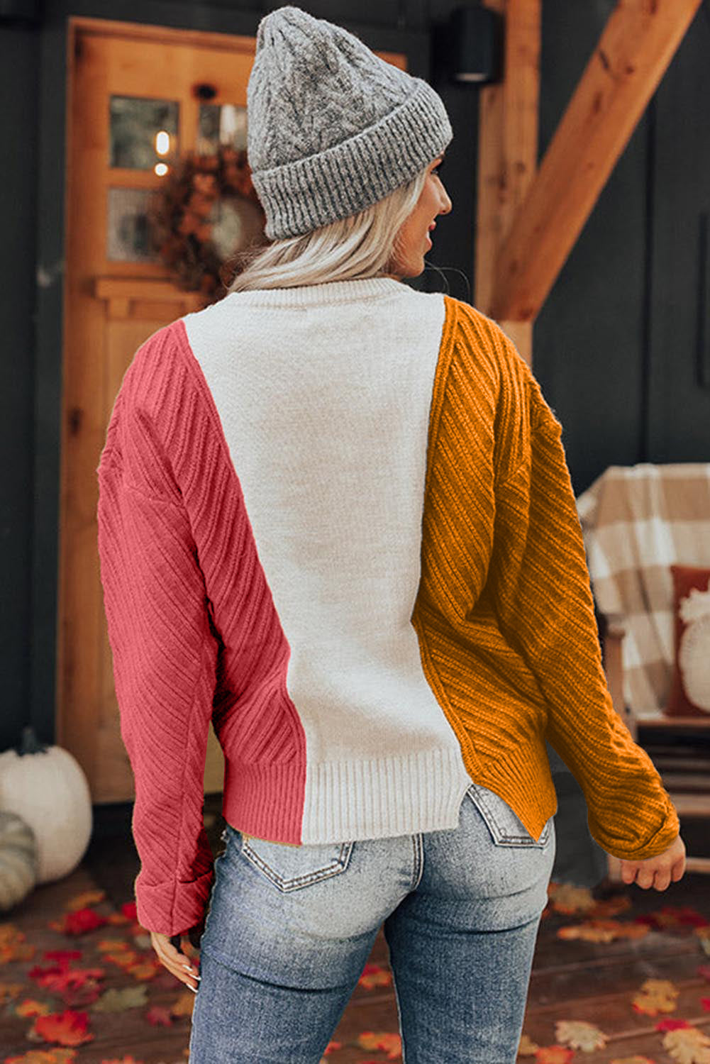 A stylish multicolor colorblock textured drop shoulder sweater displayed on a mannequin, showcasing its unique design and cozy fabric.