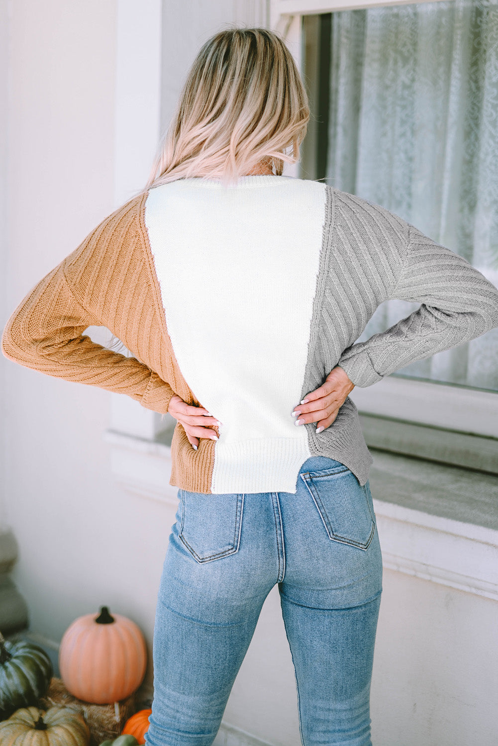 A stylish multicolor colorblock textured drop shoulder sweater displayed on a mannequin, showcasing its unique design and cozy fabric.