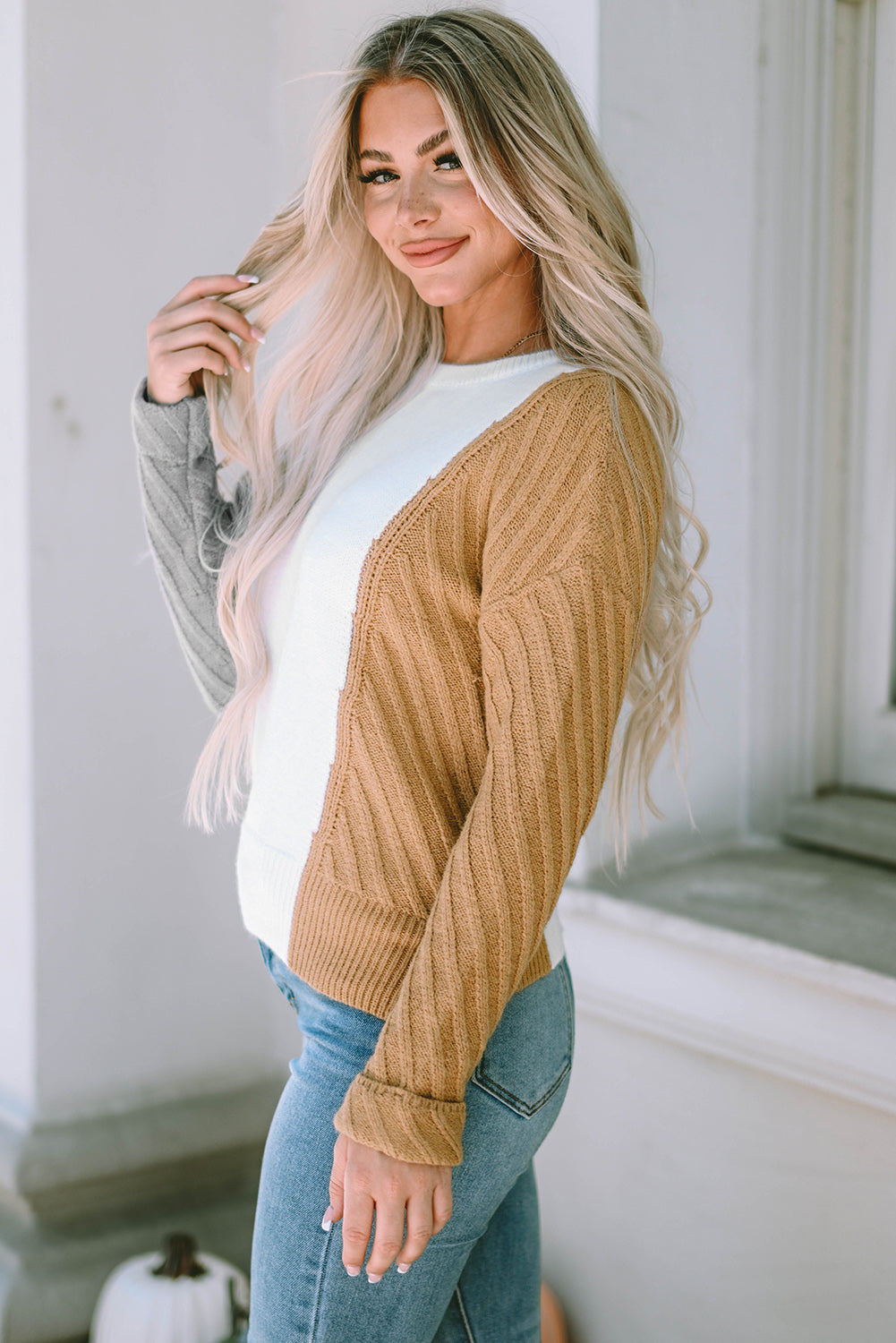 A stylish multicolor colorblock textured drop shoulder sweater displayed on a mannequin, showcasing its unique design and cozy fabric.