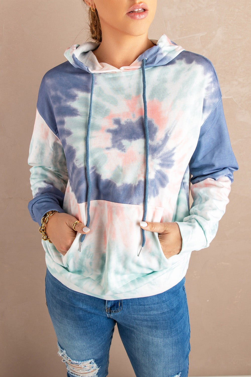 Multicolor tie-dye print pullover hoodie displayed on a mannequin, showcasing vibrant colors and a cozy design.