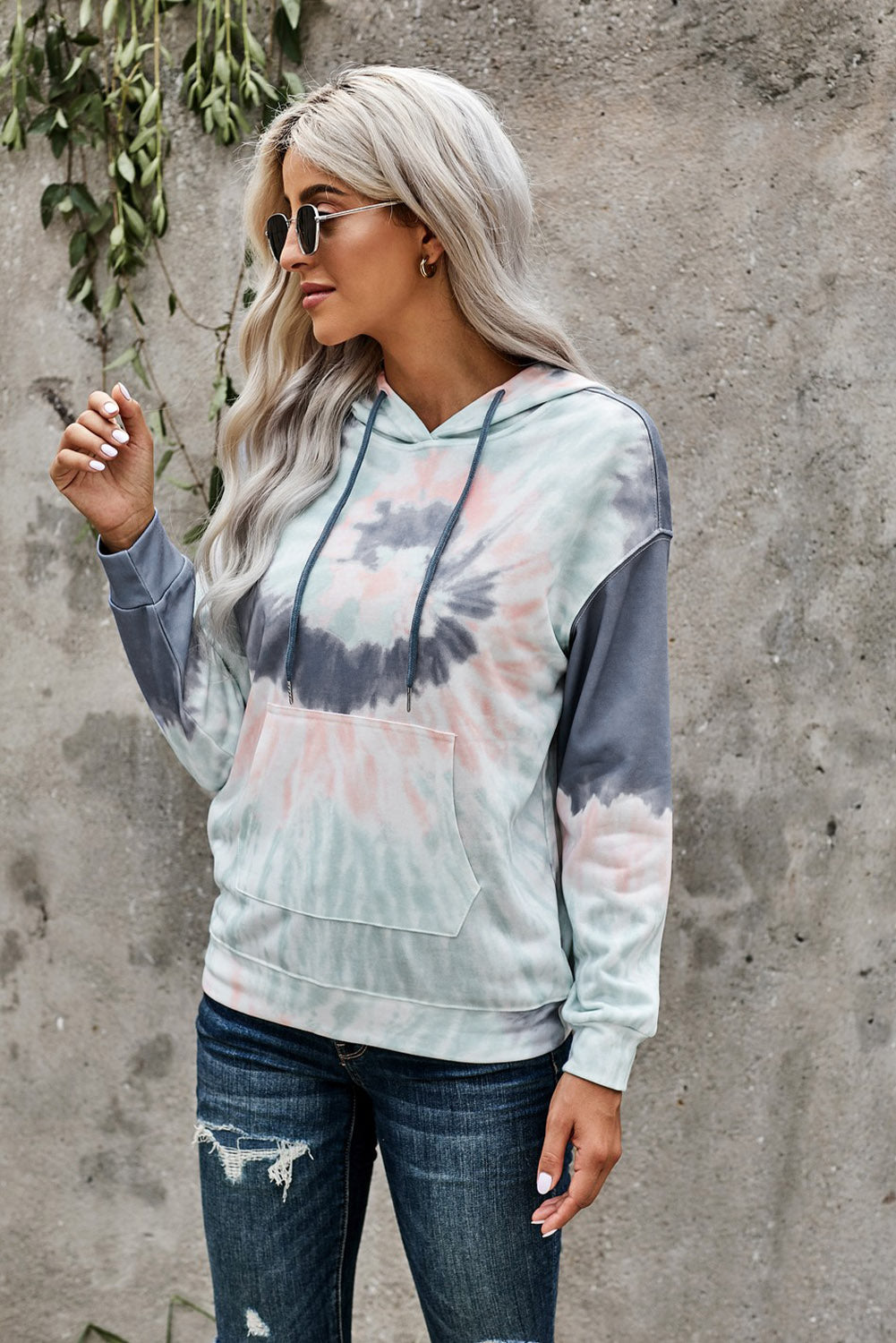 Multicolor tie-dye print pullover hoodie displayed on a mannequin, showcasing vibrant colors and a cozy design.