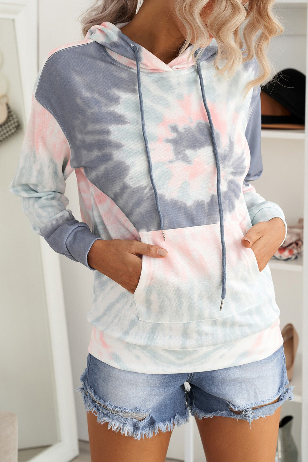 Multicolor tie-dye print pullover hoodie displayed on a mannequin, showcasing vibrant colors and a cozy design.