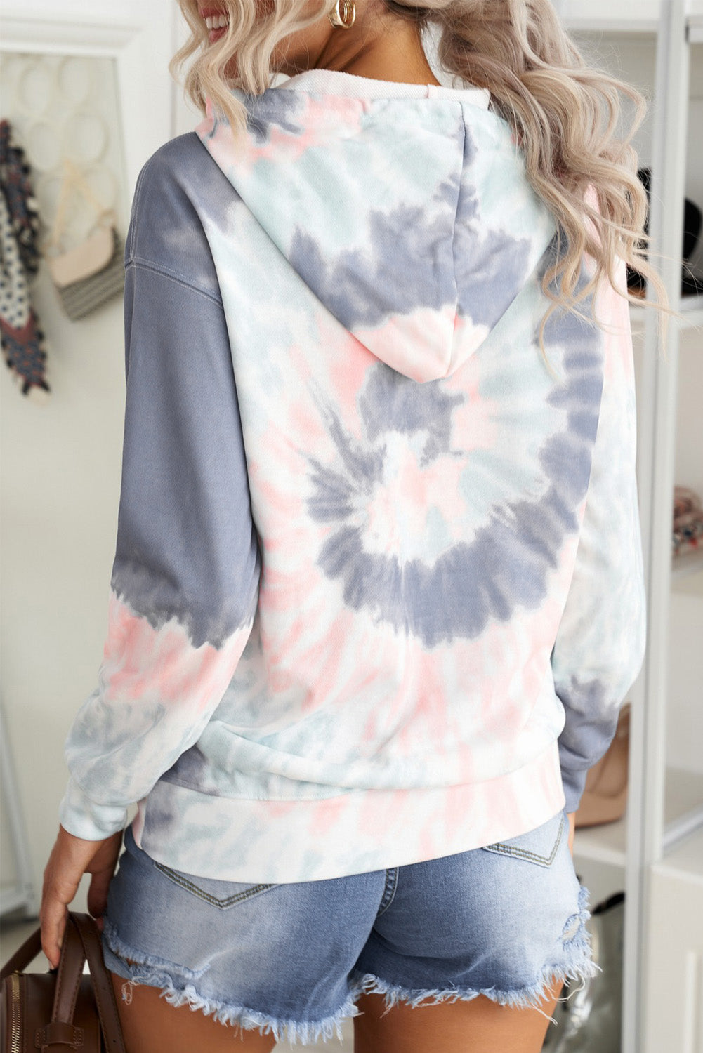 Multicolor tie-dye print pullover hoodie displayed on a mannequin, showcasing vibrant colors and a cozy design.