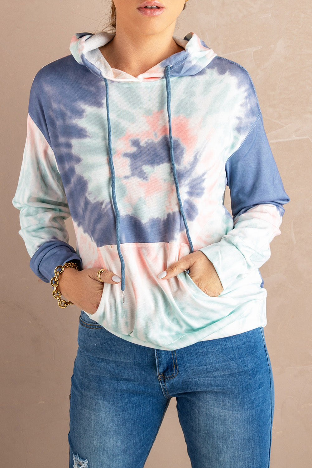 Multicolor tie-dye print pullover hoodie displayed on a mannequin, showcasing vibrant colors and a cozy design.