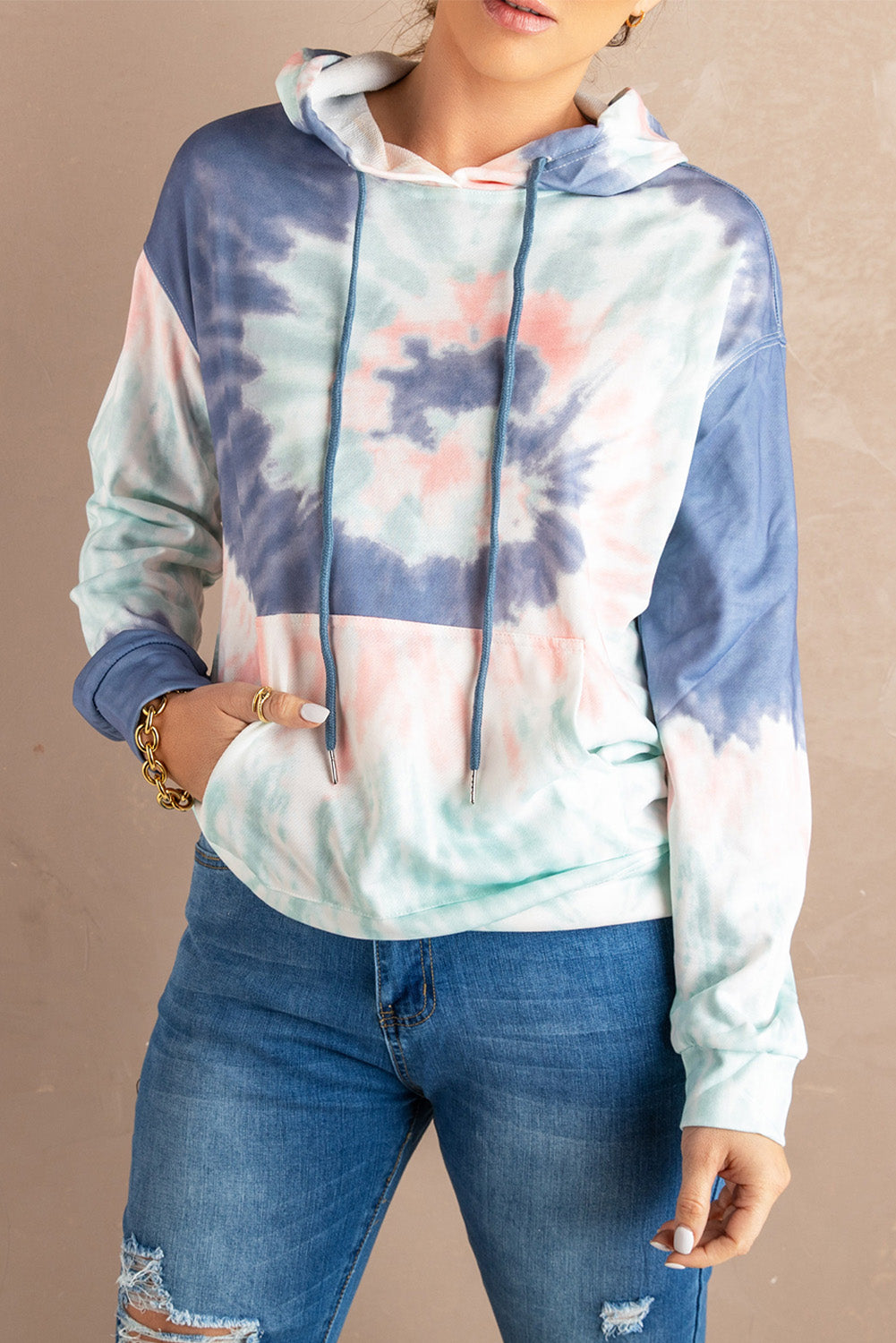 Multicolor tie-dye print pullover hoodie displayed on a mannequin, showcasing vibrant colors and a cozy design.